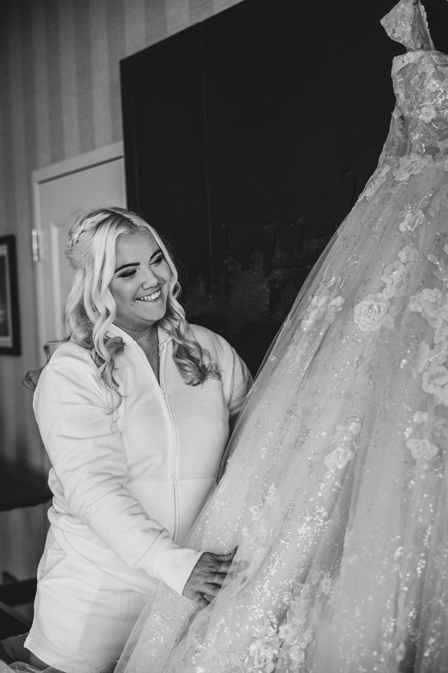 A sequence of black and white photos showing a white wedding gown with intricate lace details.