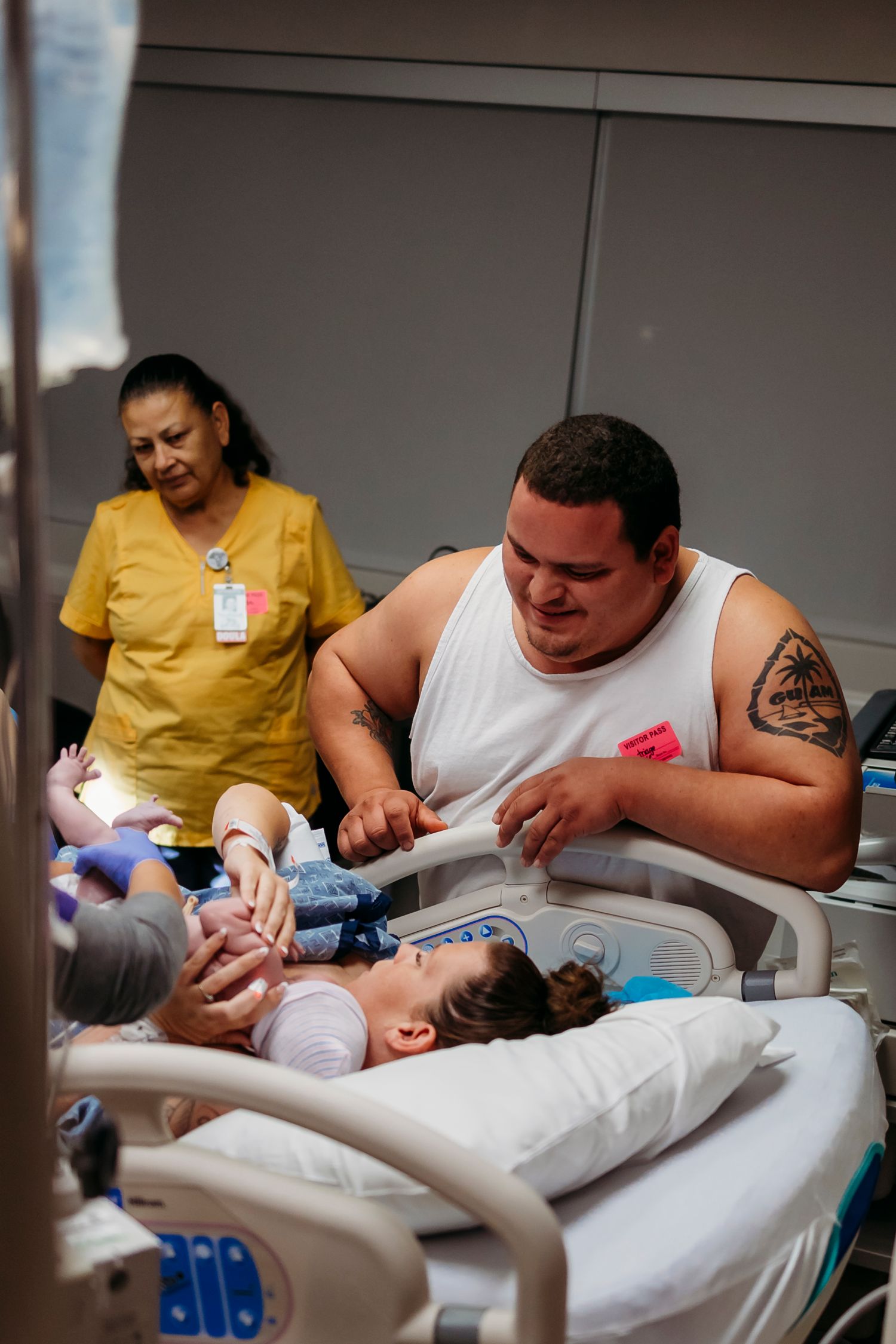 Medical staff attending to a patient in a hospital room.