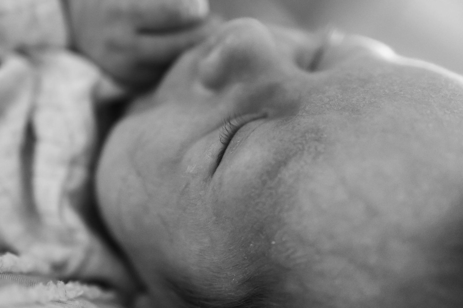 Intimate black and white portrait showing gentle connection.