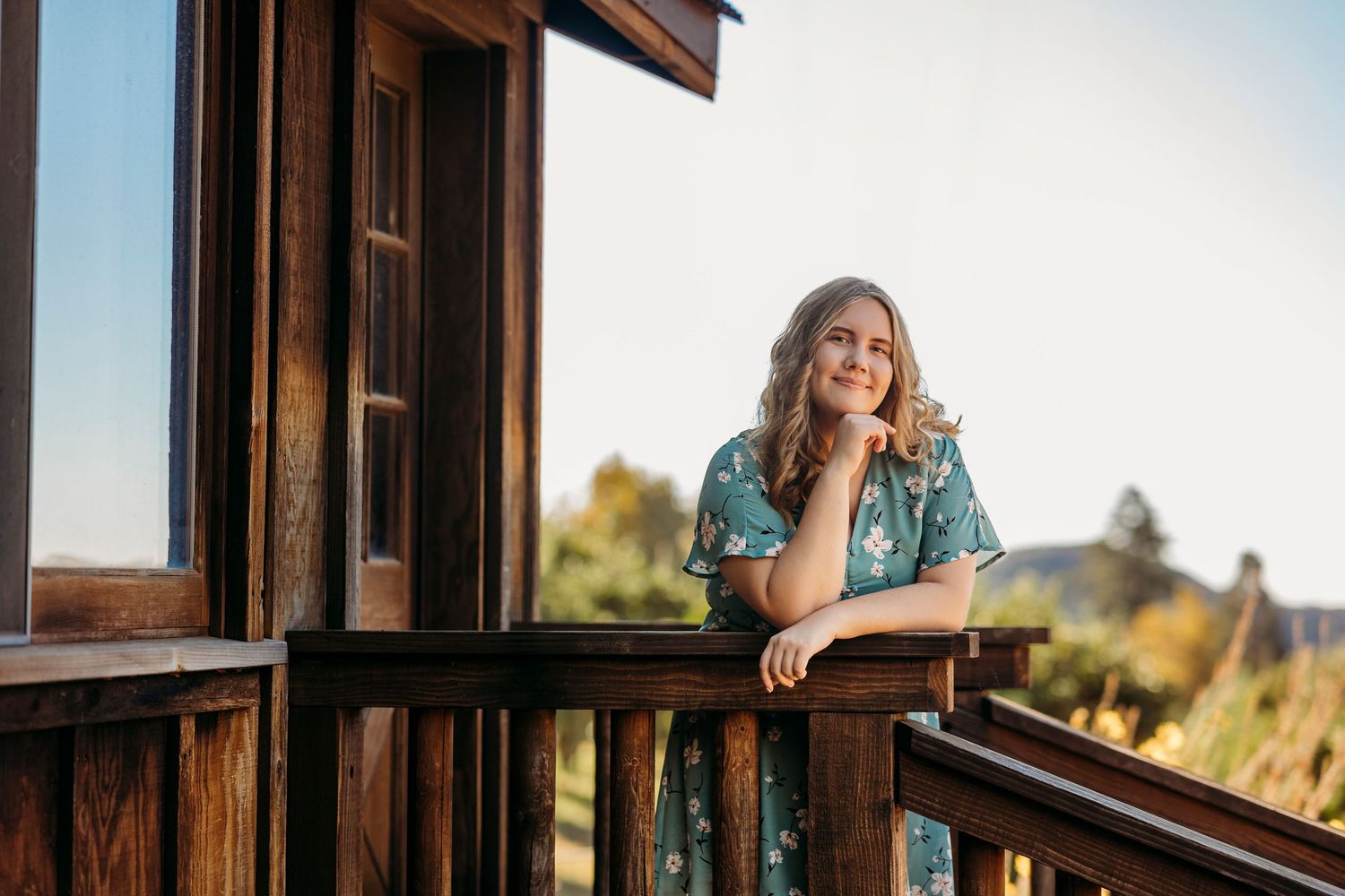 Rustic wooden cabin porch with mountain views in afternoon light in Oak Glen.