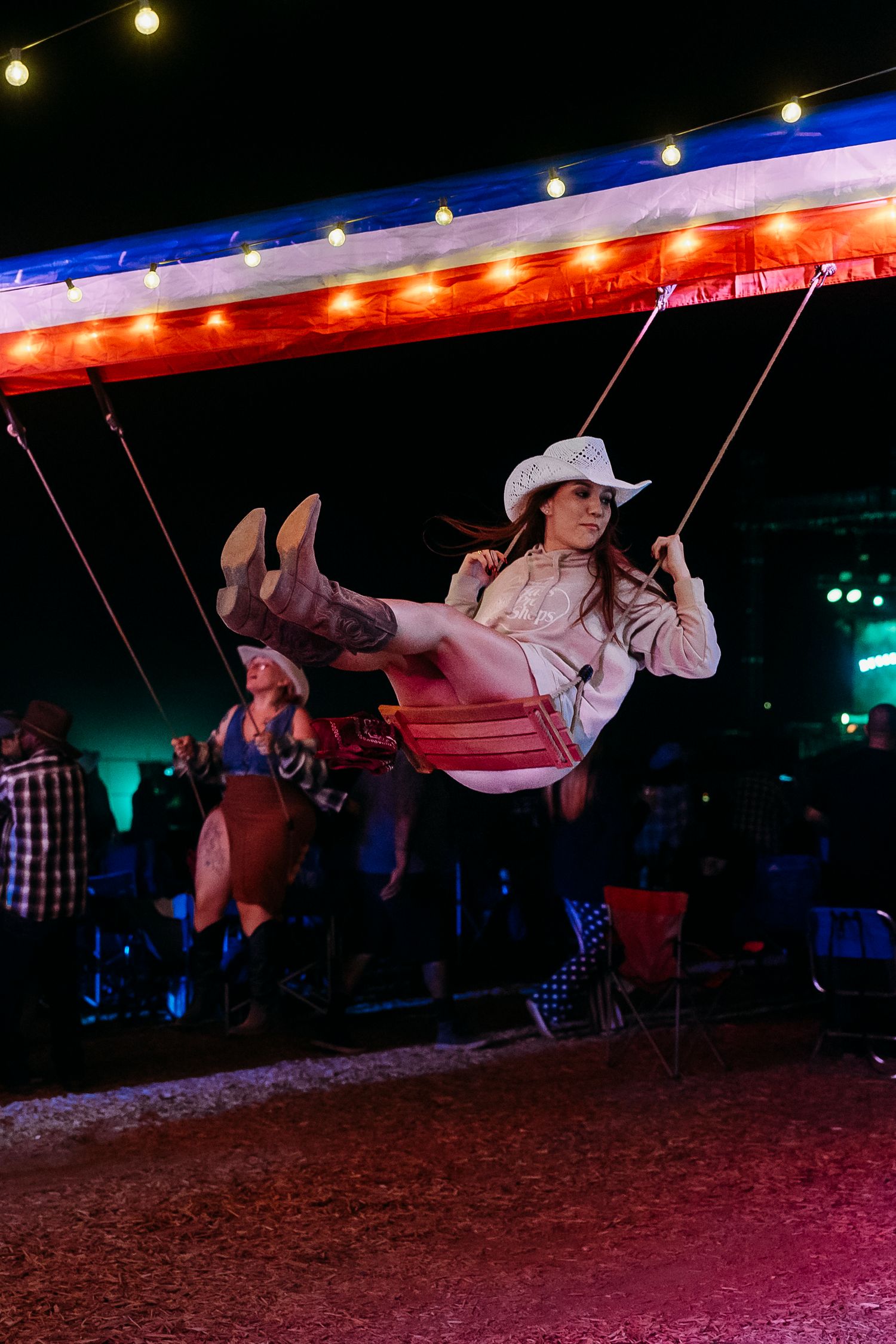 A sequence of dance moves showing a partner being flipped and spun under dramatic colored lighting at a dance event.