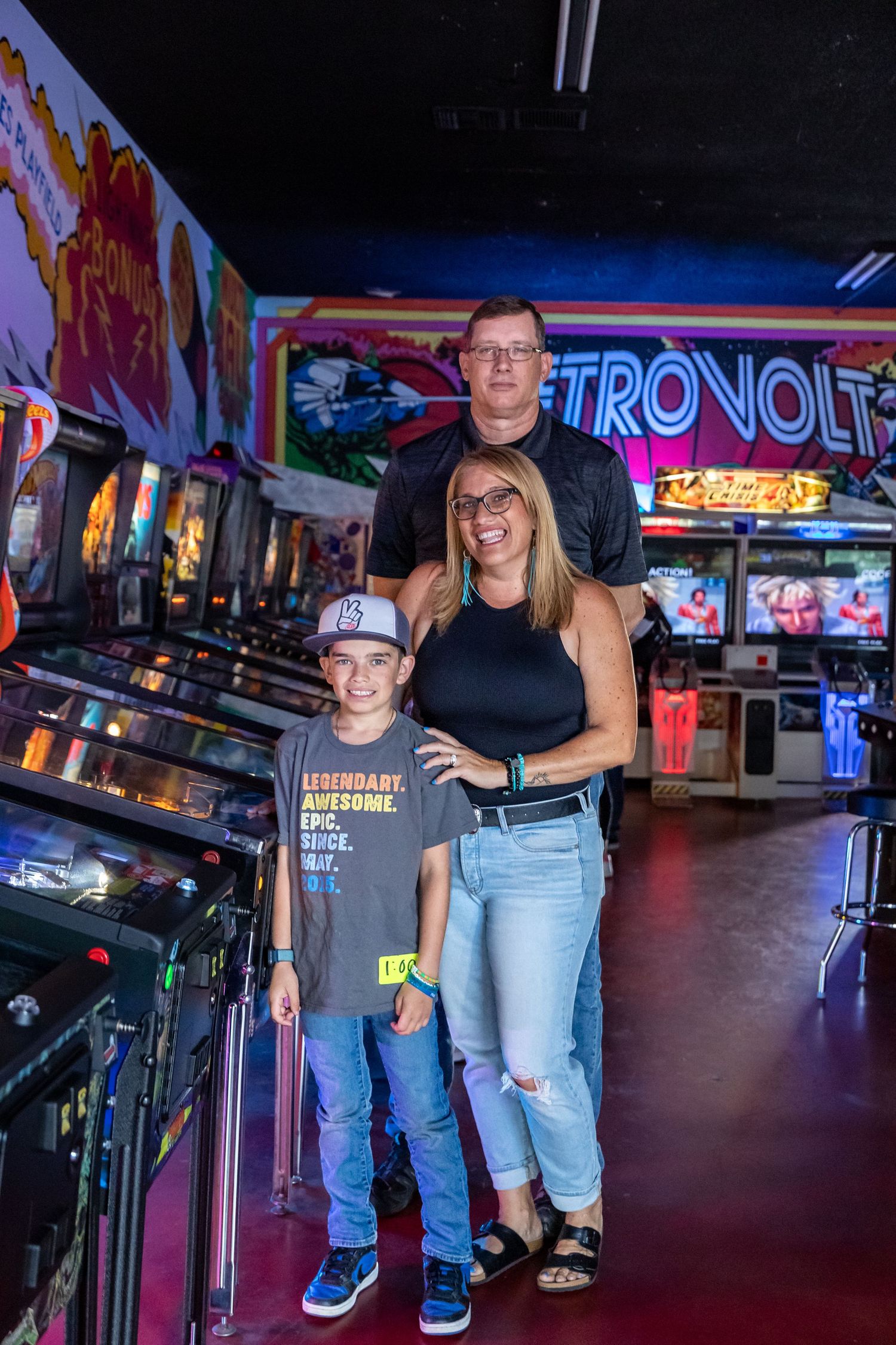 Arcade gaming area with neon signage and retro game cabinets creates nostalgic atmosphere.