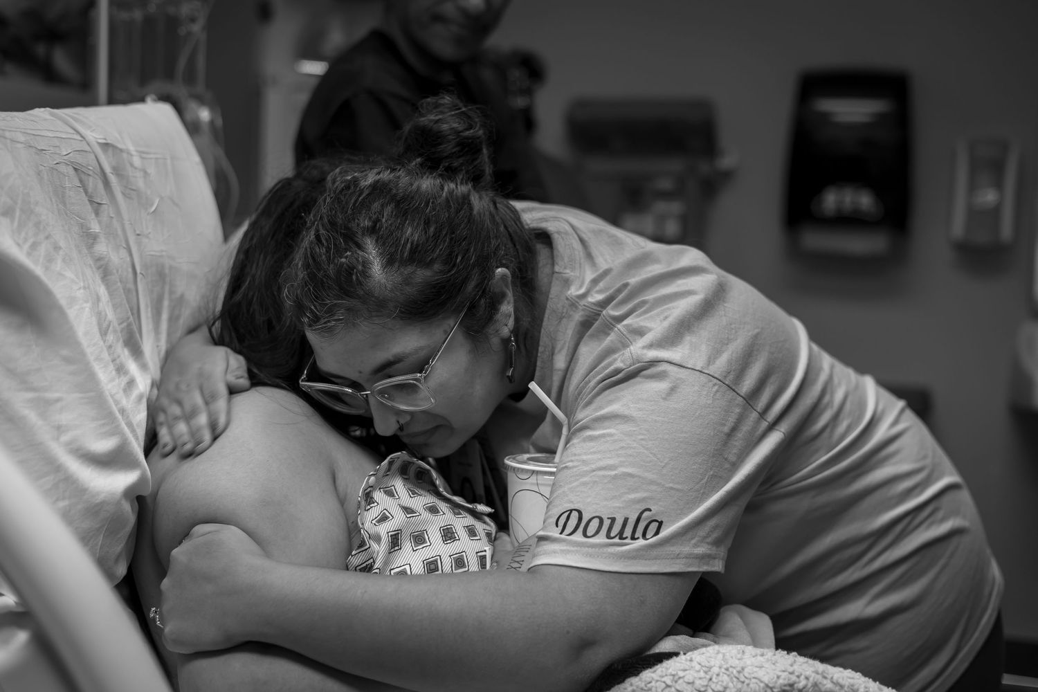 Medical staff providing support during hospital childbirth.
