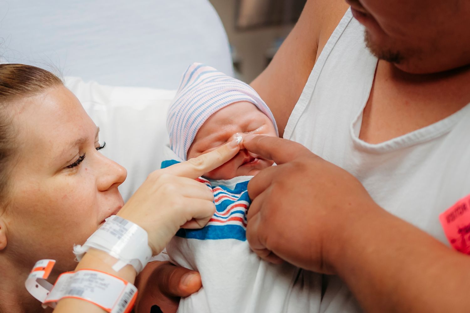 Medical professional administering nasal spray medication in a clinical setting.