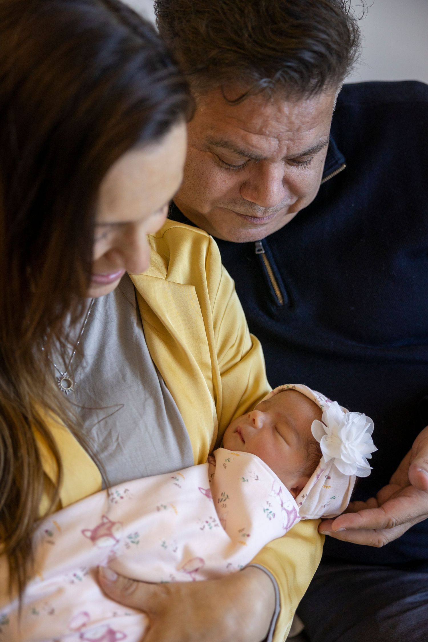 Mom and dad holding newborn in Corona hospital