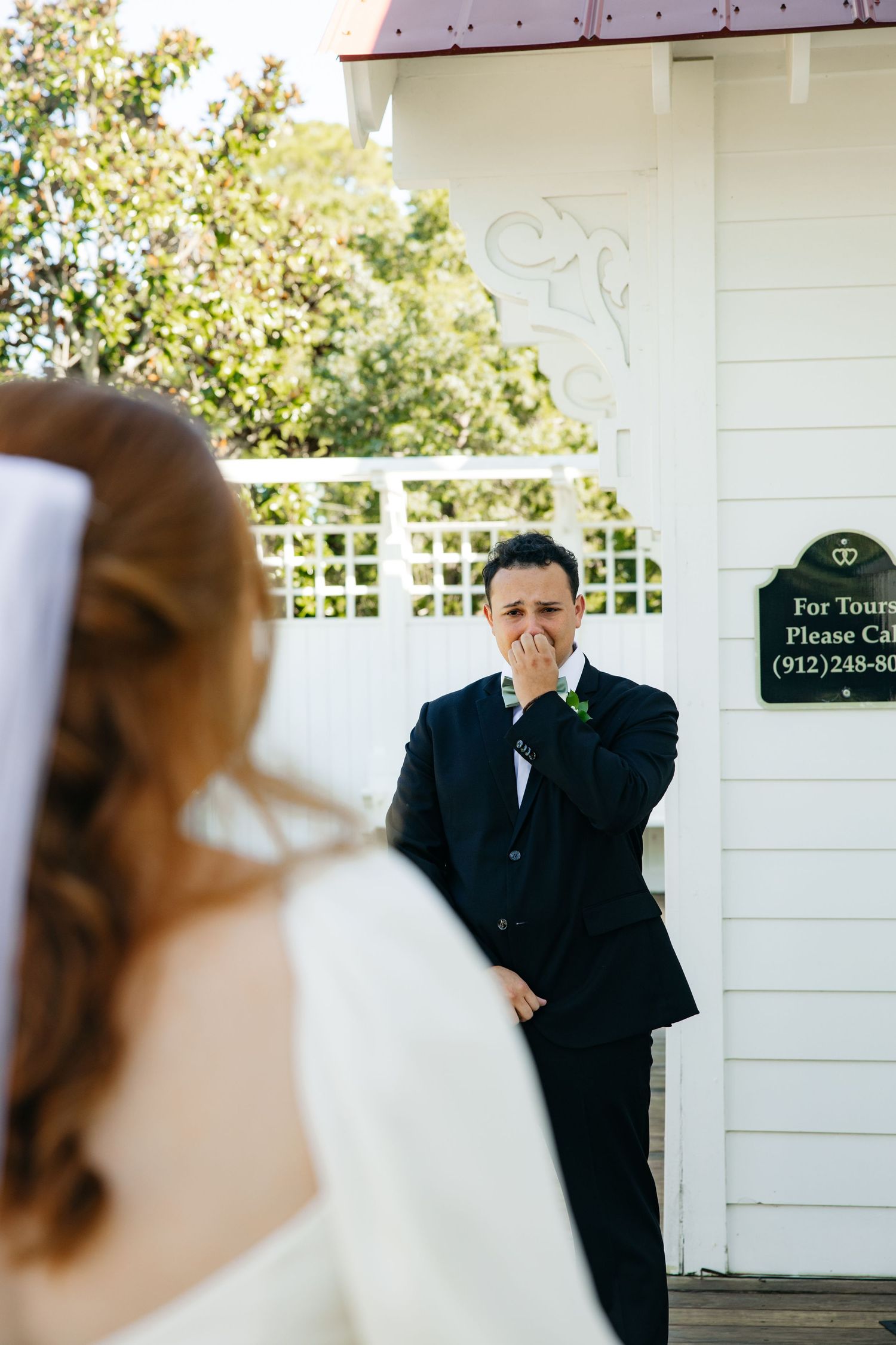 A sequence of candid wedding photos showing a first look moment between a couple on their special day.