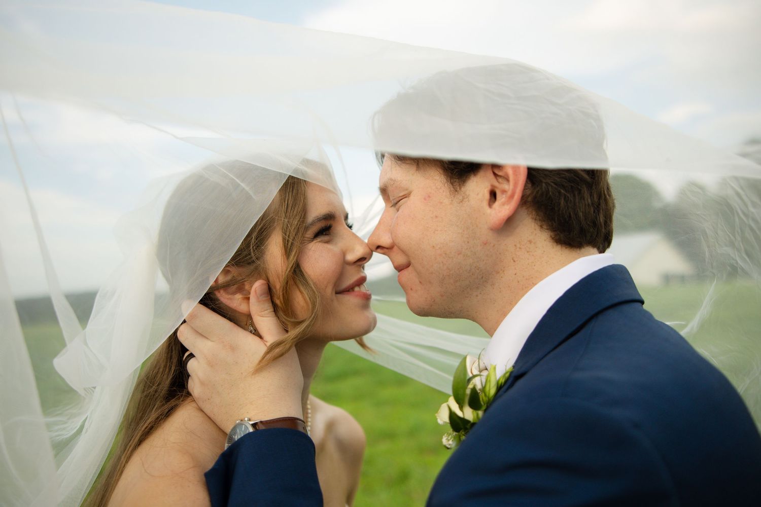 A couple in wedding attire share romantic kisses in a series of outdoor photos.
