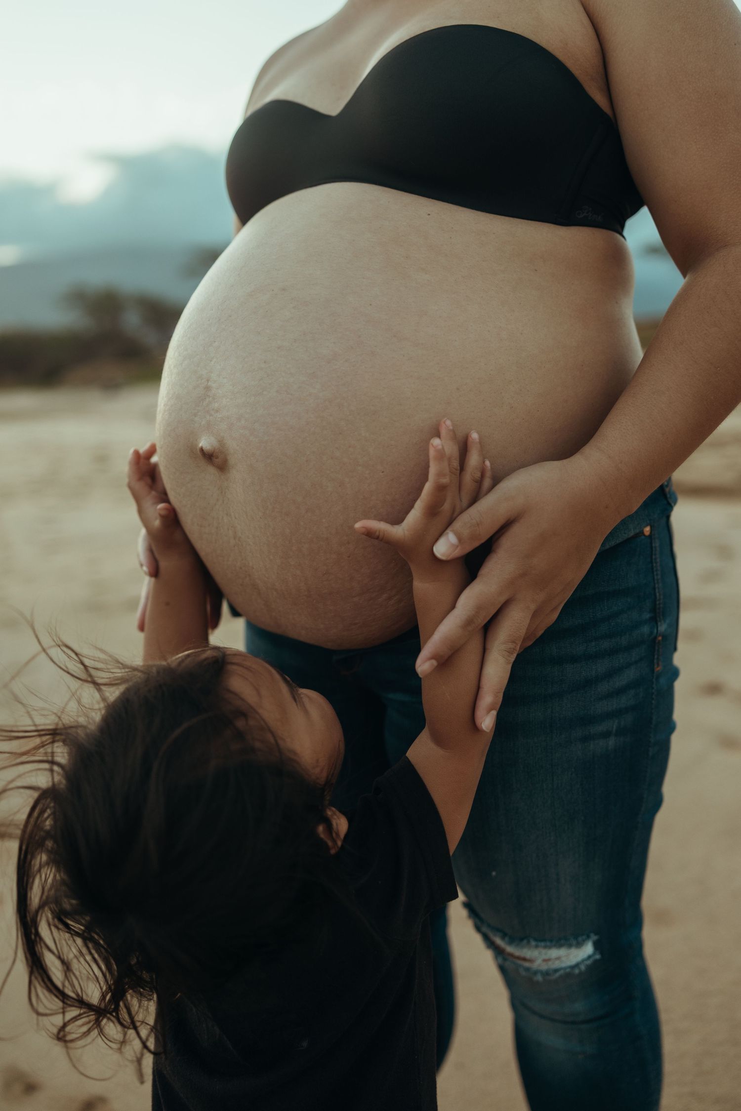 A series of five artistic maternity photos showing a pregnant woman's silhouette against a soft outdoor background.