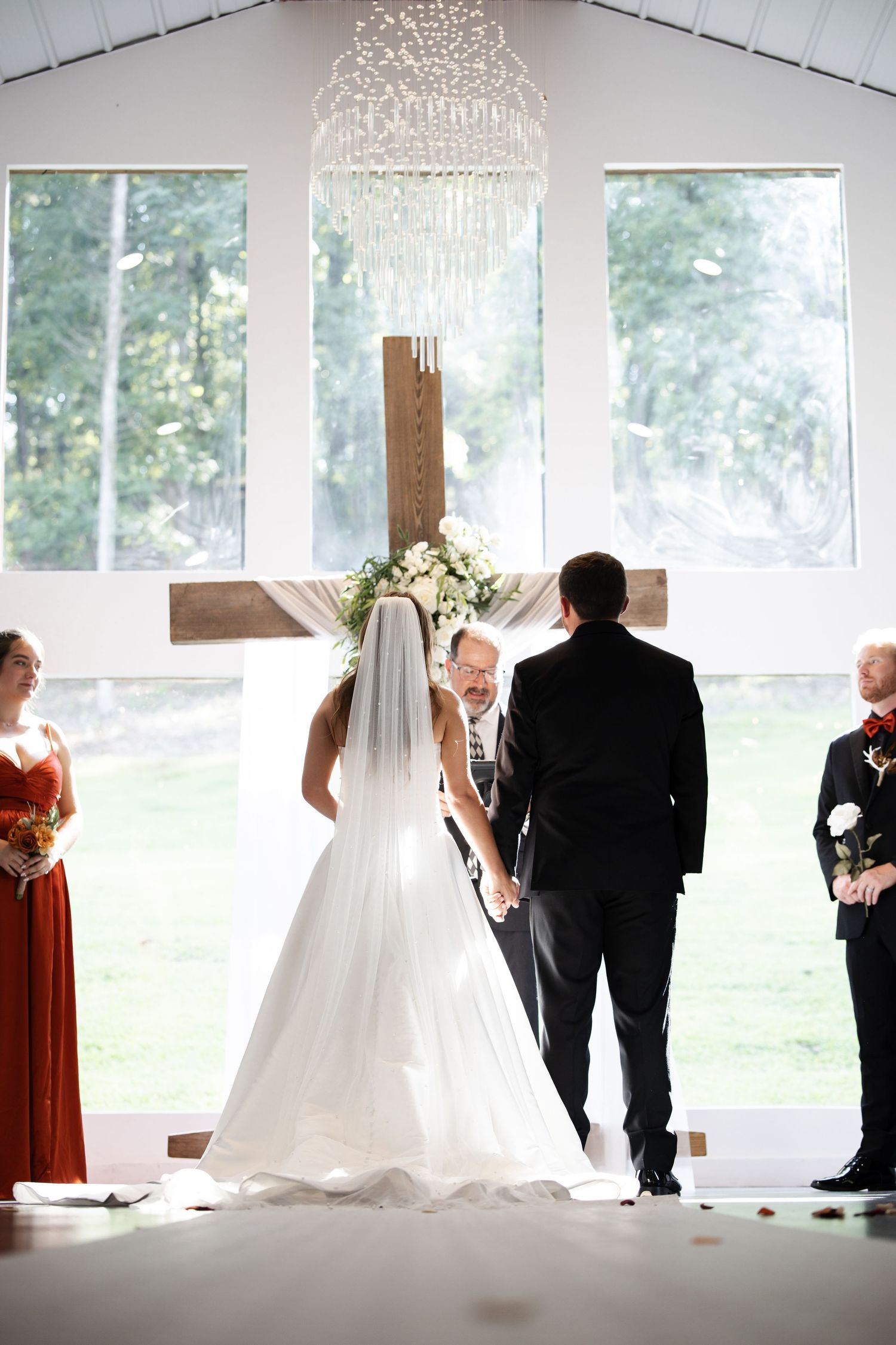 A wedding ceremony sequence shows a bride and groom at the altar with guests in an elegant room with chandeliers.