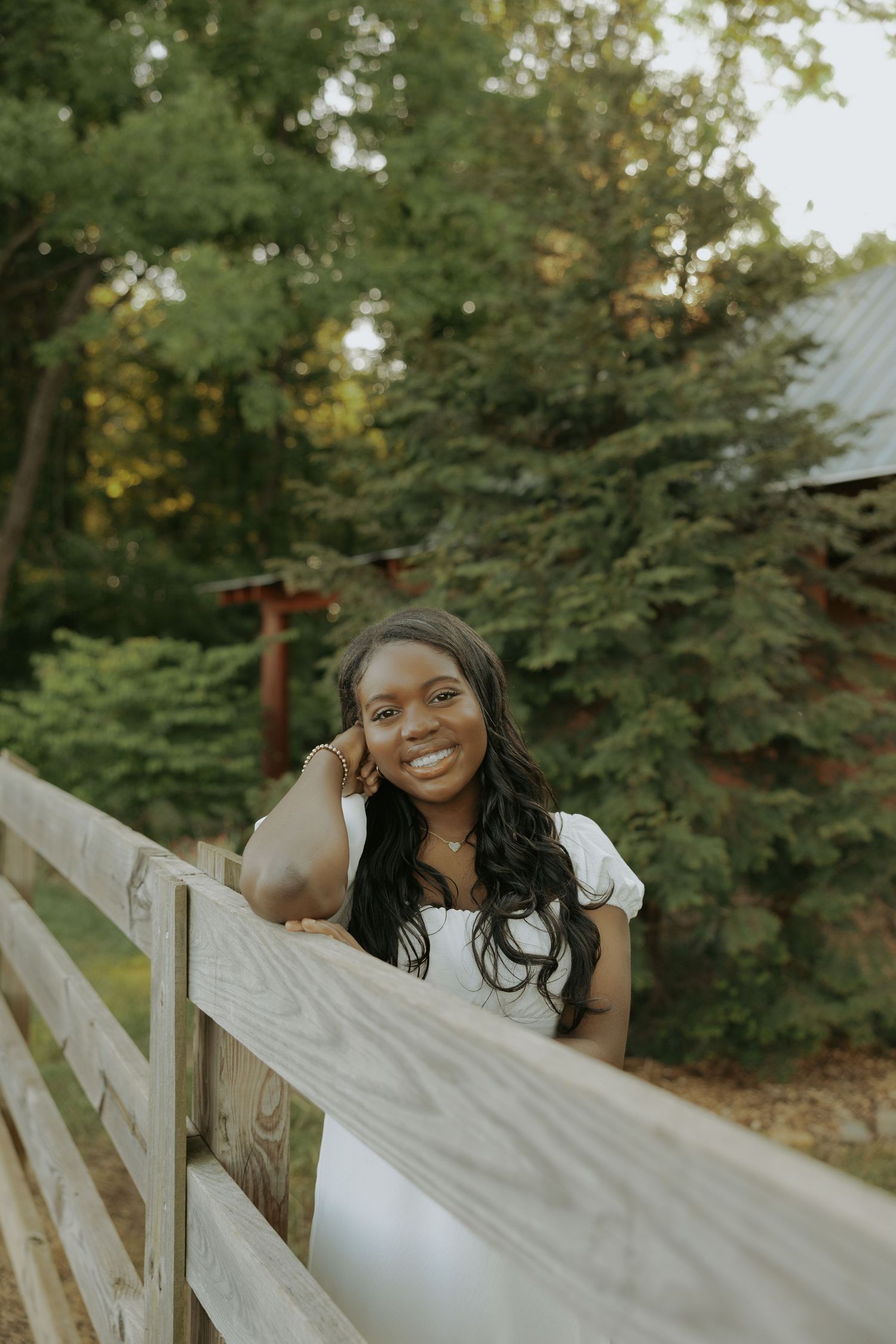 A candid moment captured on a wooden bridge with trees in the background.