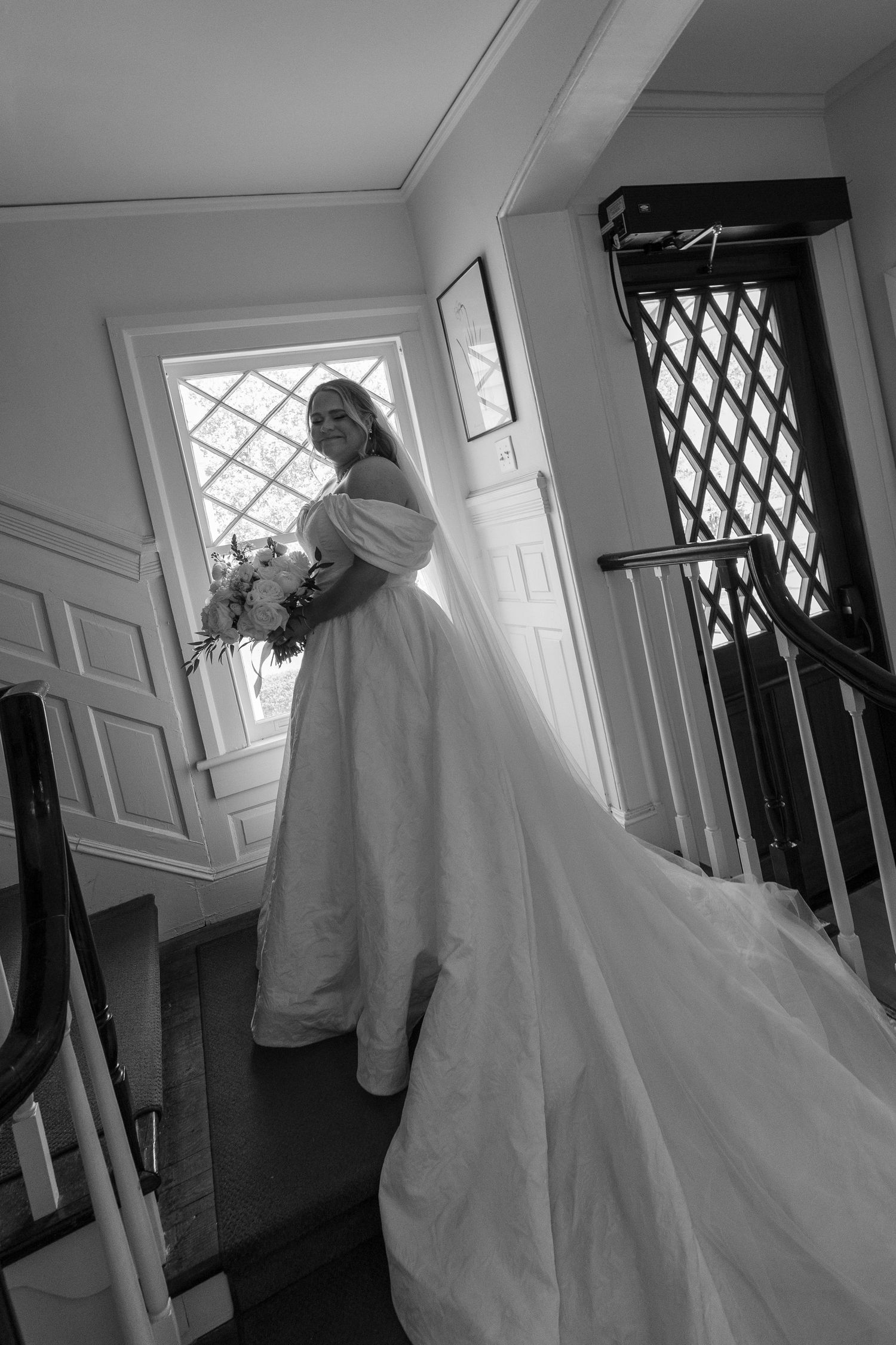 A sequence of black and white photos showing a couple in wedding attire near a window in an interior hallway.