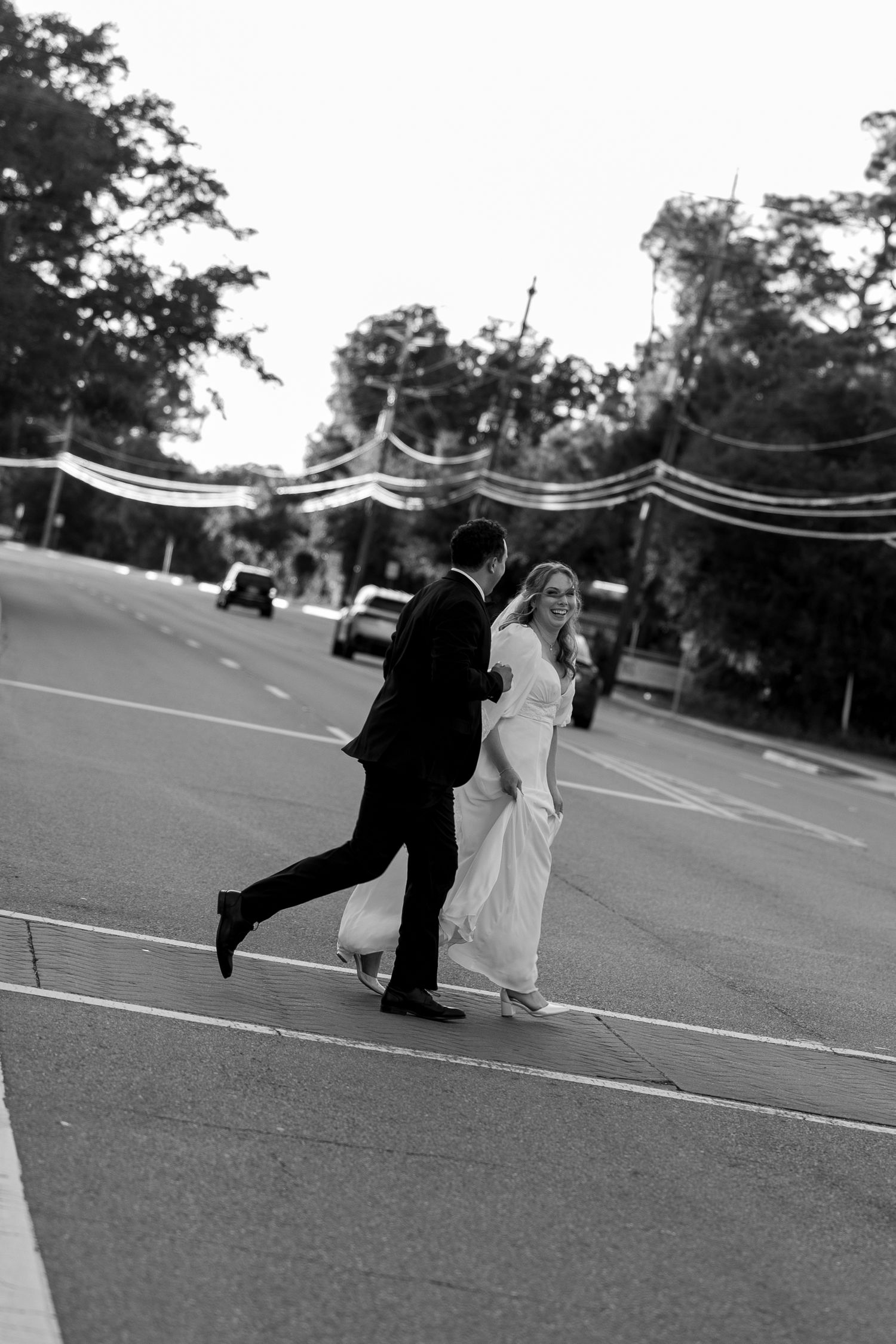 Black and white photo sequence showing a couple dancing and dipping in a parking lot.