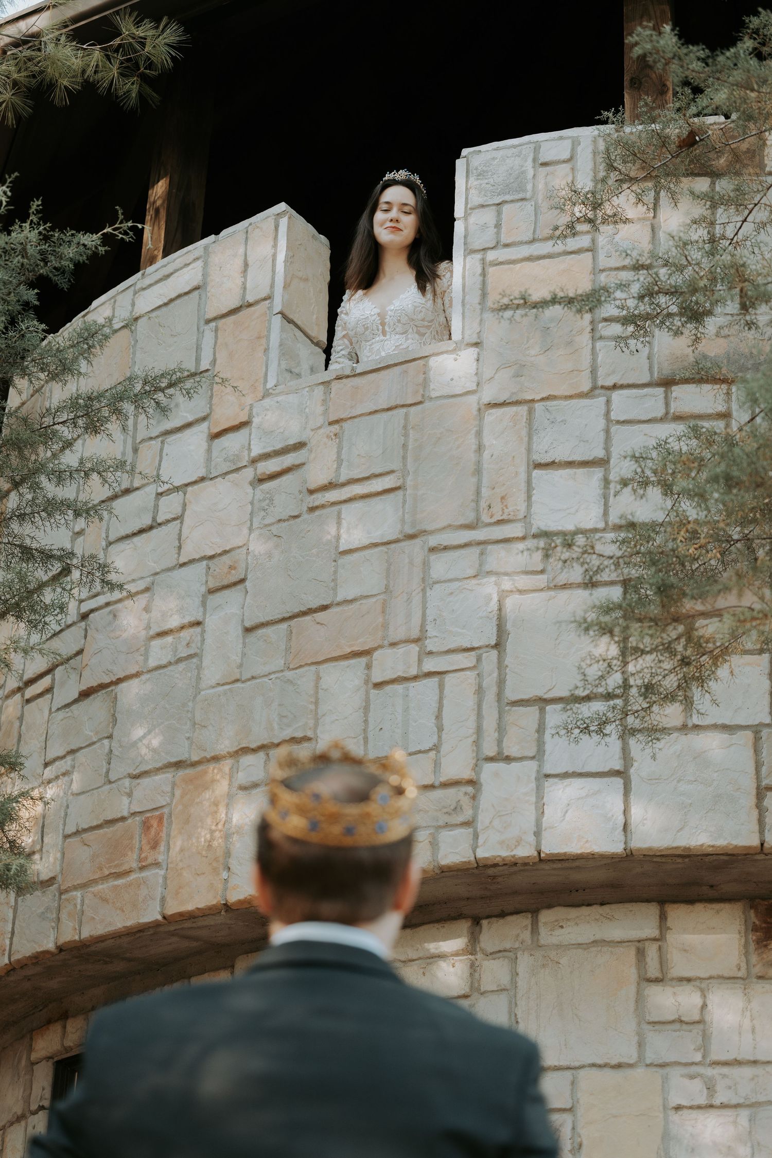 Romantic first look moment between couple at stone castle wall.