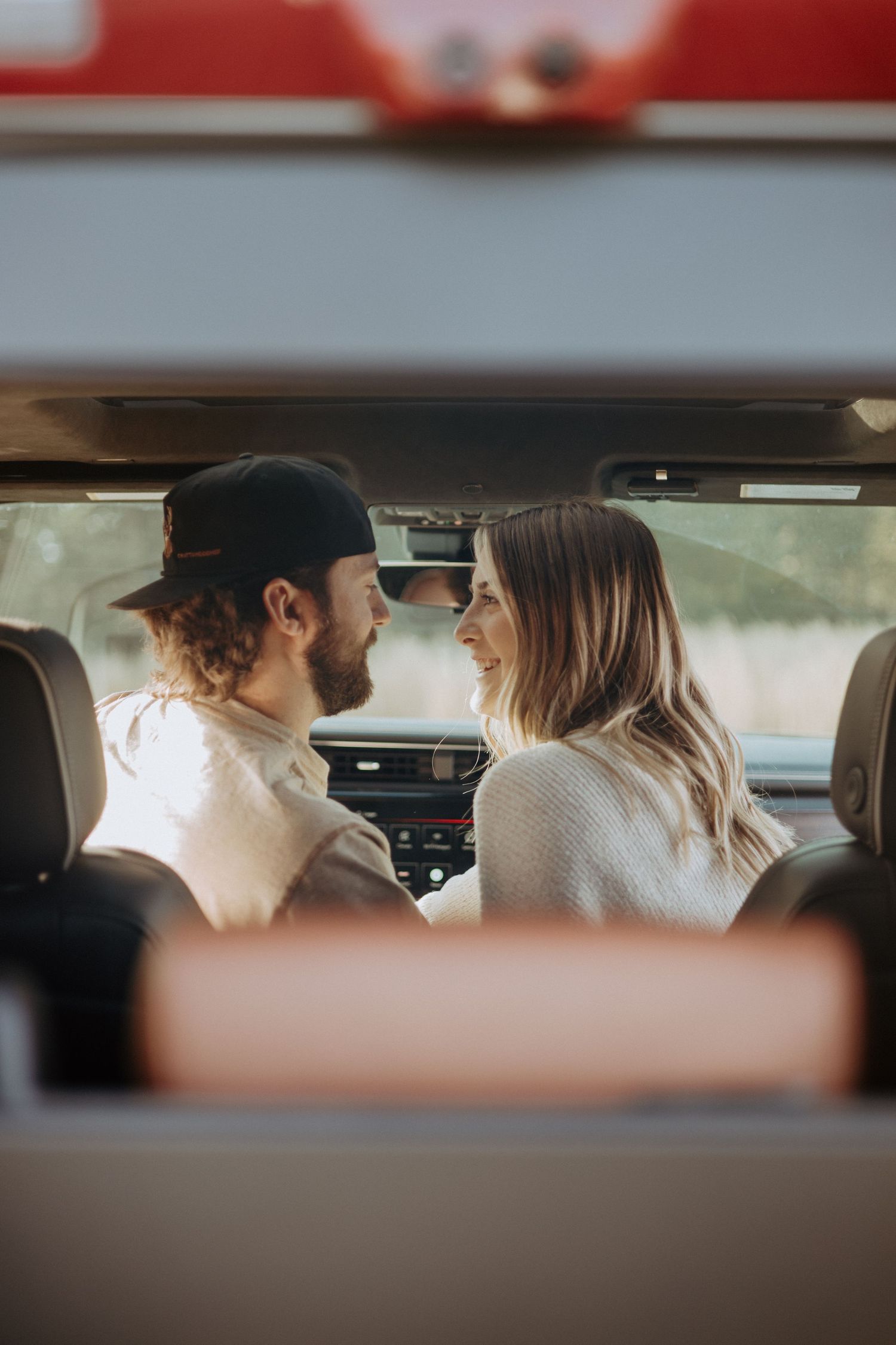 Interior car photographs showing tender moments between a couple.