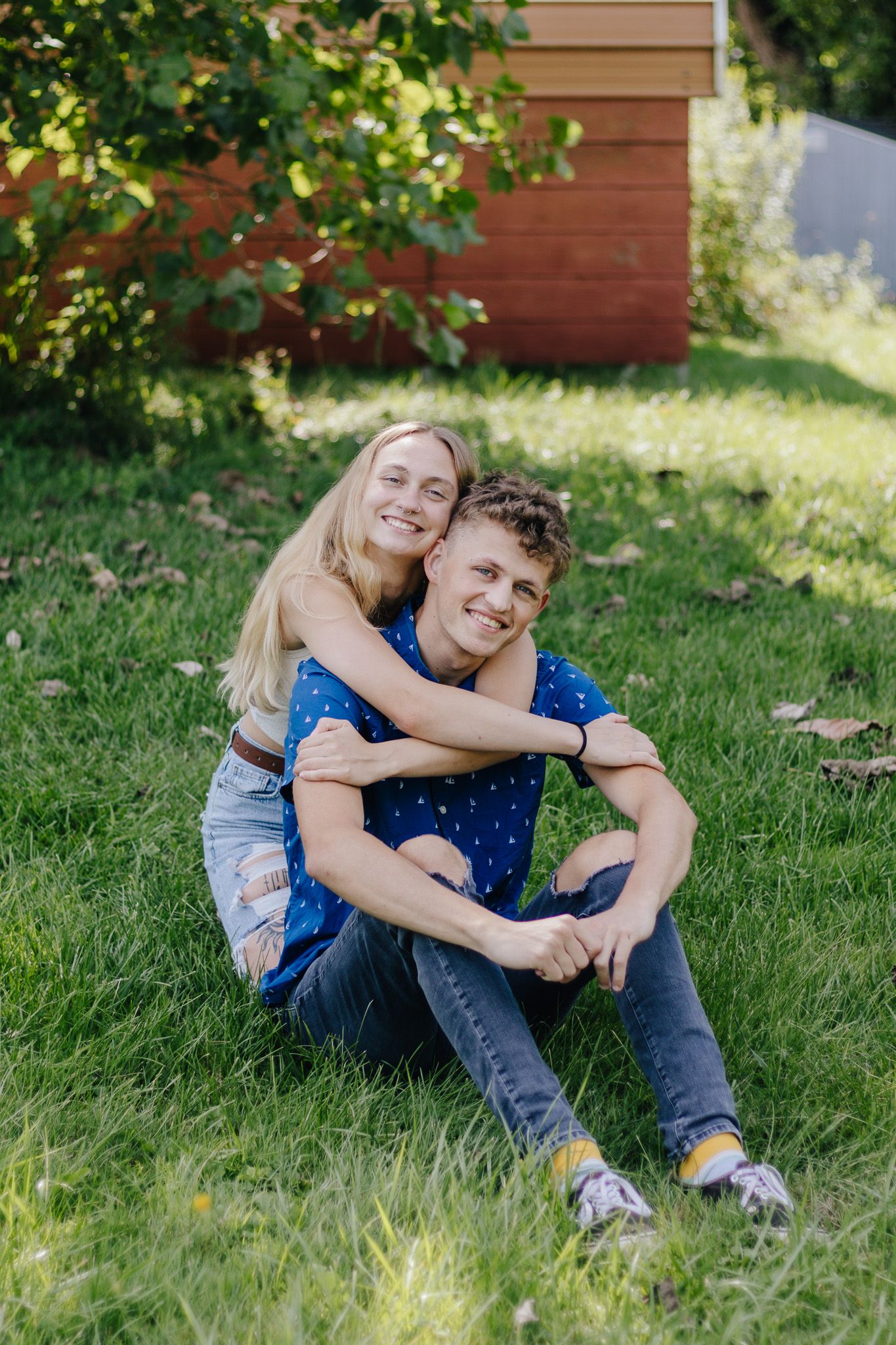 Couple smiling in the grass during photography session.