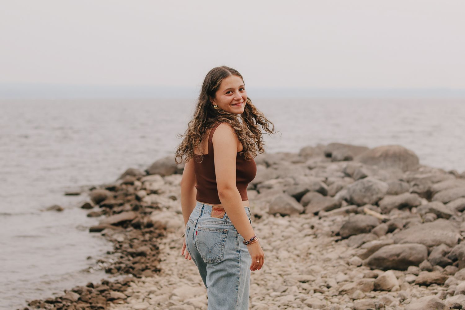 Candid portrait of client walking and laughing during senior session.