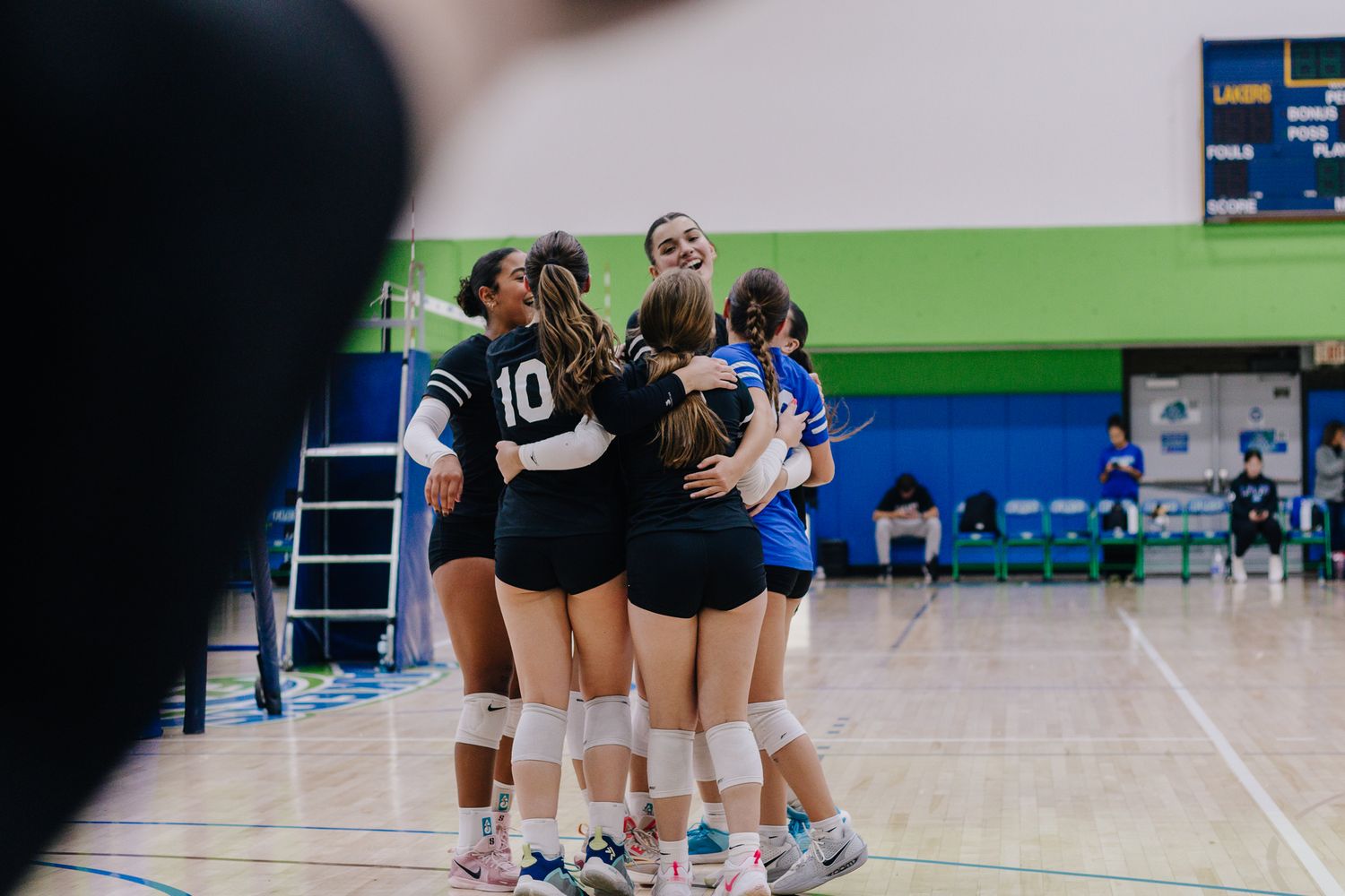 Volleyball team celebrating a win.