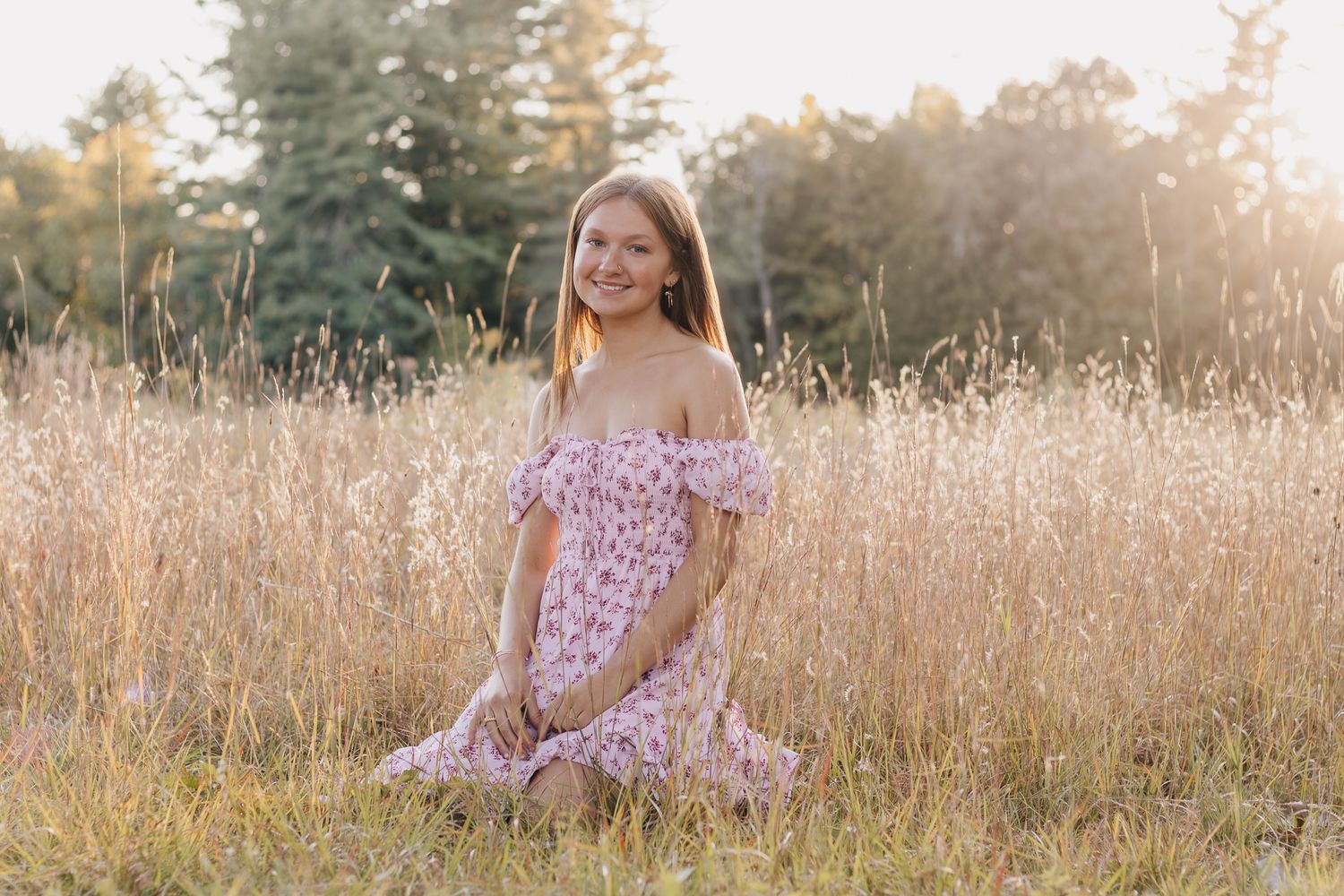 Senior portrait with sunset glow and soft tones.