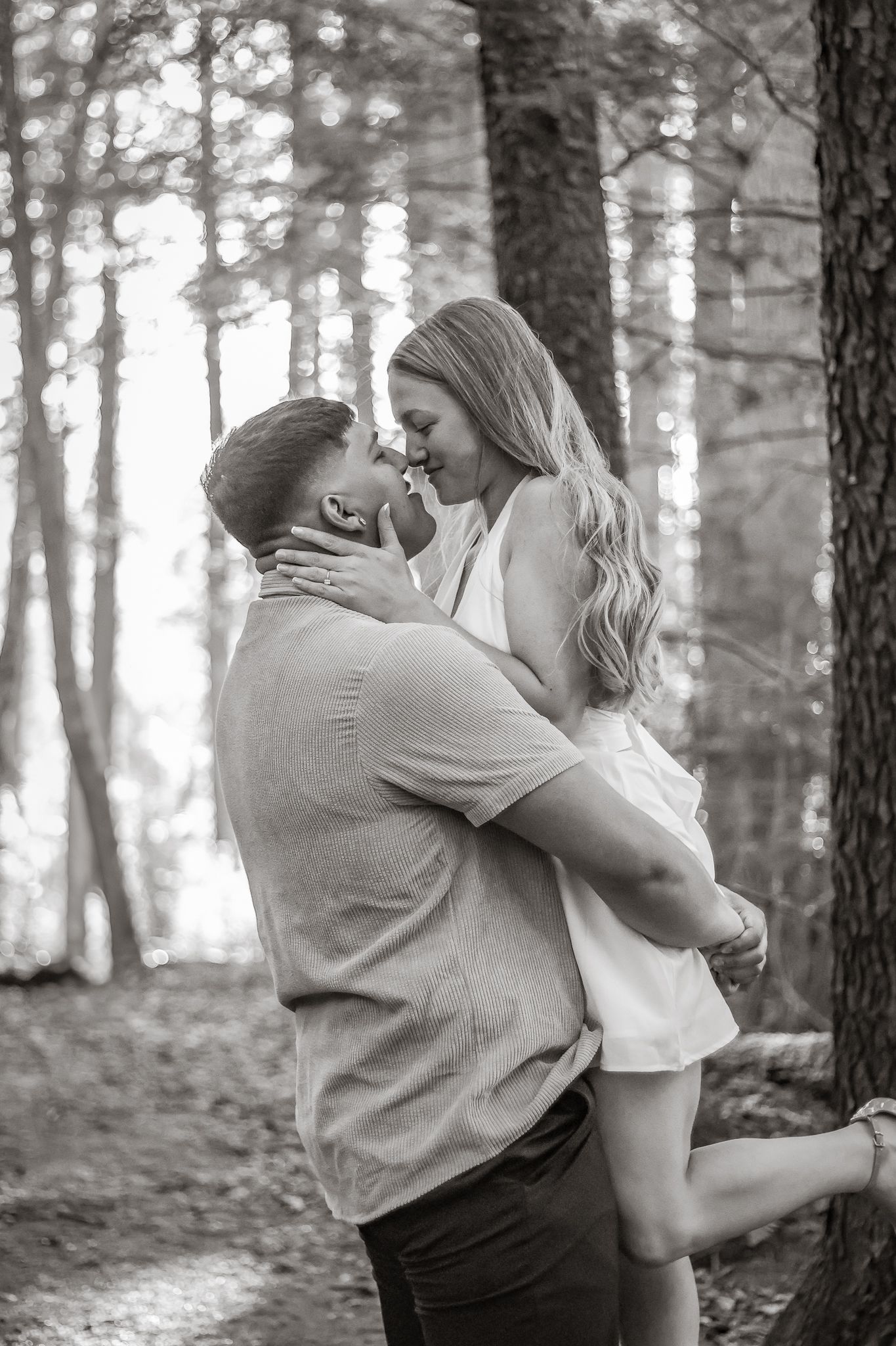 Romantic couple hugging on a trail during photo session.