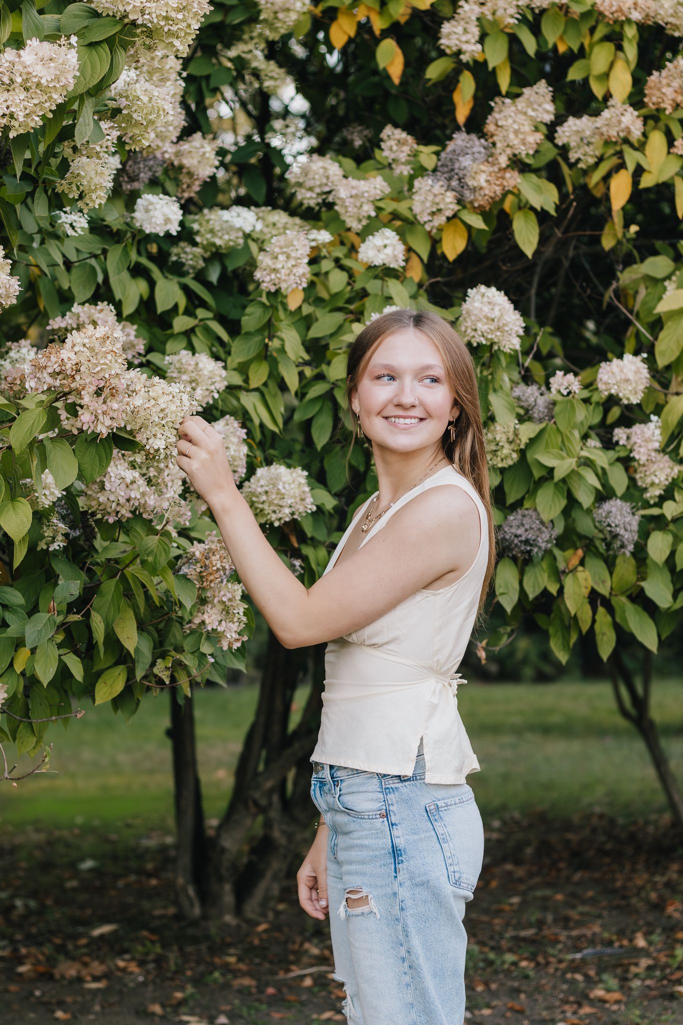Senior portrait session outdoors with flowers.
