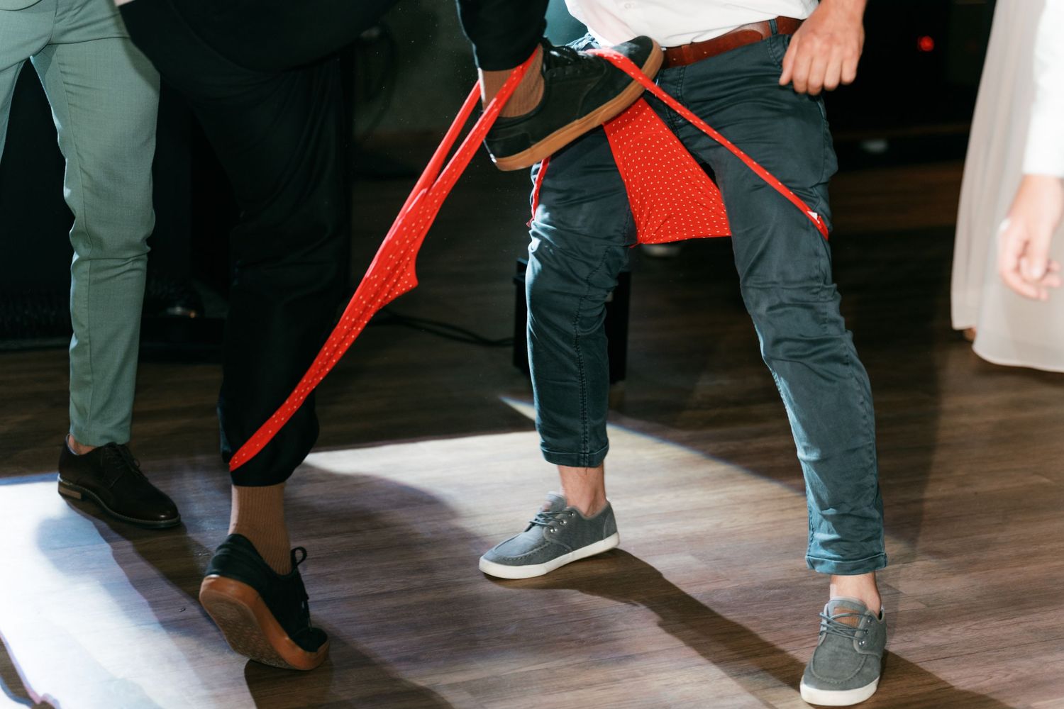 Close-up of wedding guests legs during a lively dance at the wedding reception. Italy wedding photographer and filmmaker