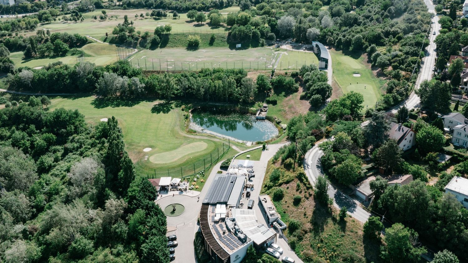Aerial view of elegant wedding venue surrounded by lush greenery and golf course. Italy wedding photographer and filmmaker