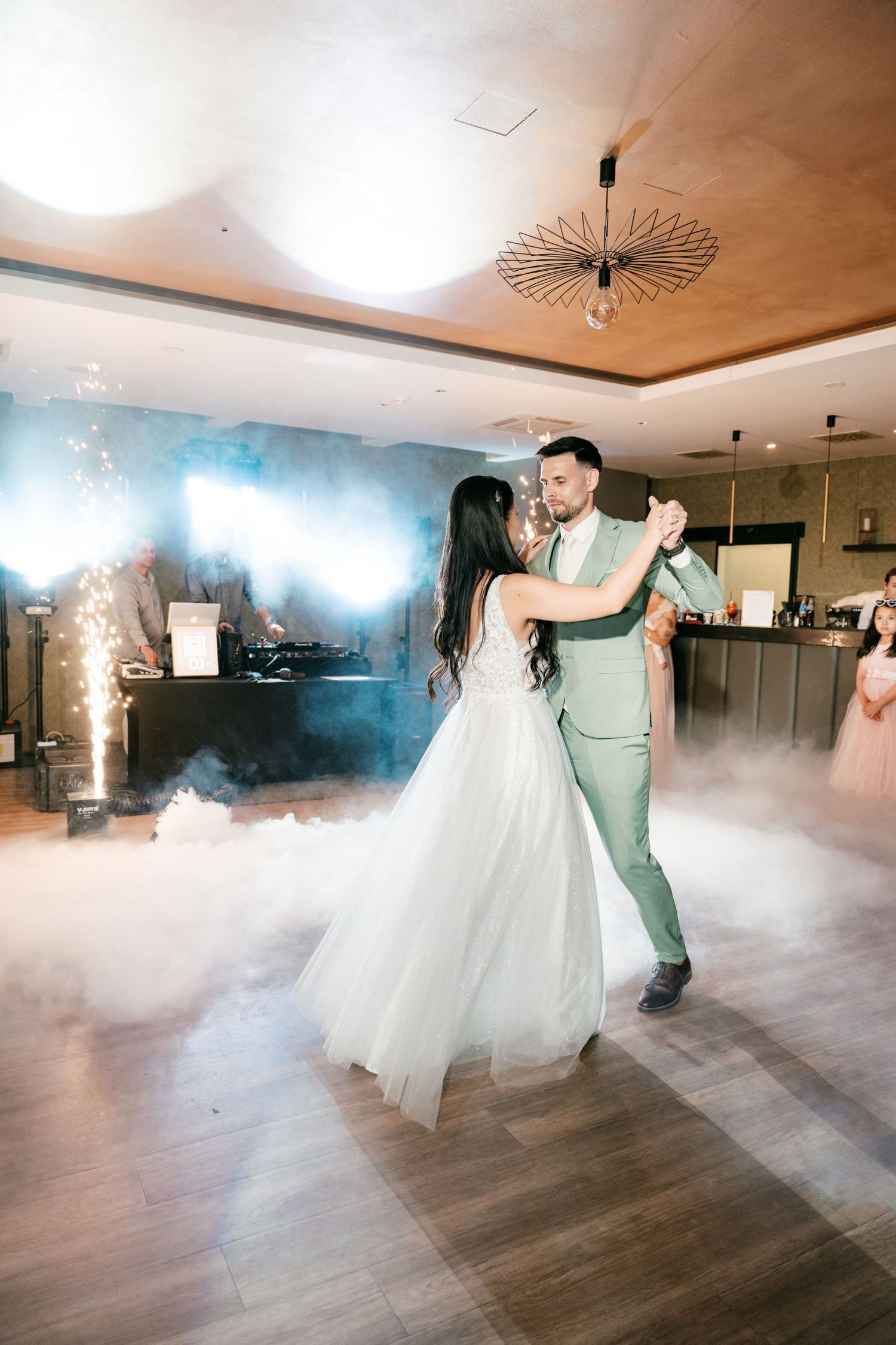 Bride and groom share first dance surrounded by fog and sparks. Italy wedding photographer and filmmaker