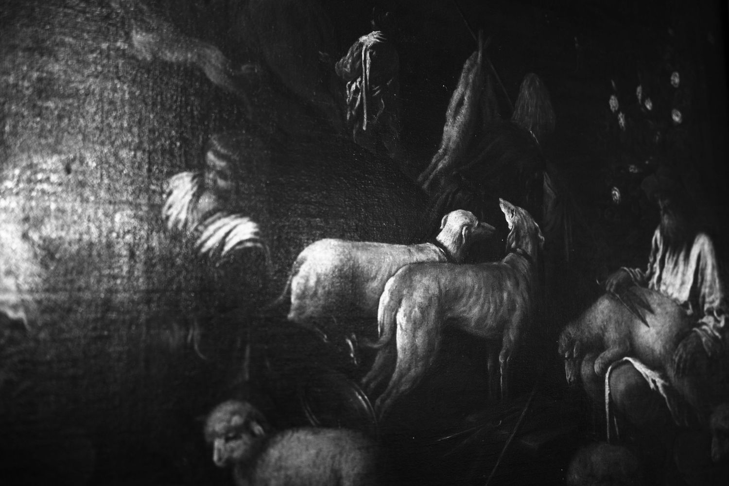 Dark Baroque-style painting of sheep and lambs gathered in a shadowy pastoral scene with a seated shepherd figure at the right.