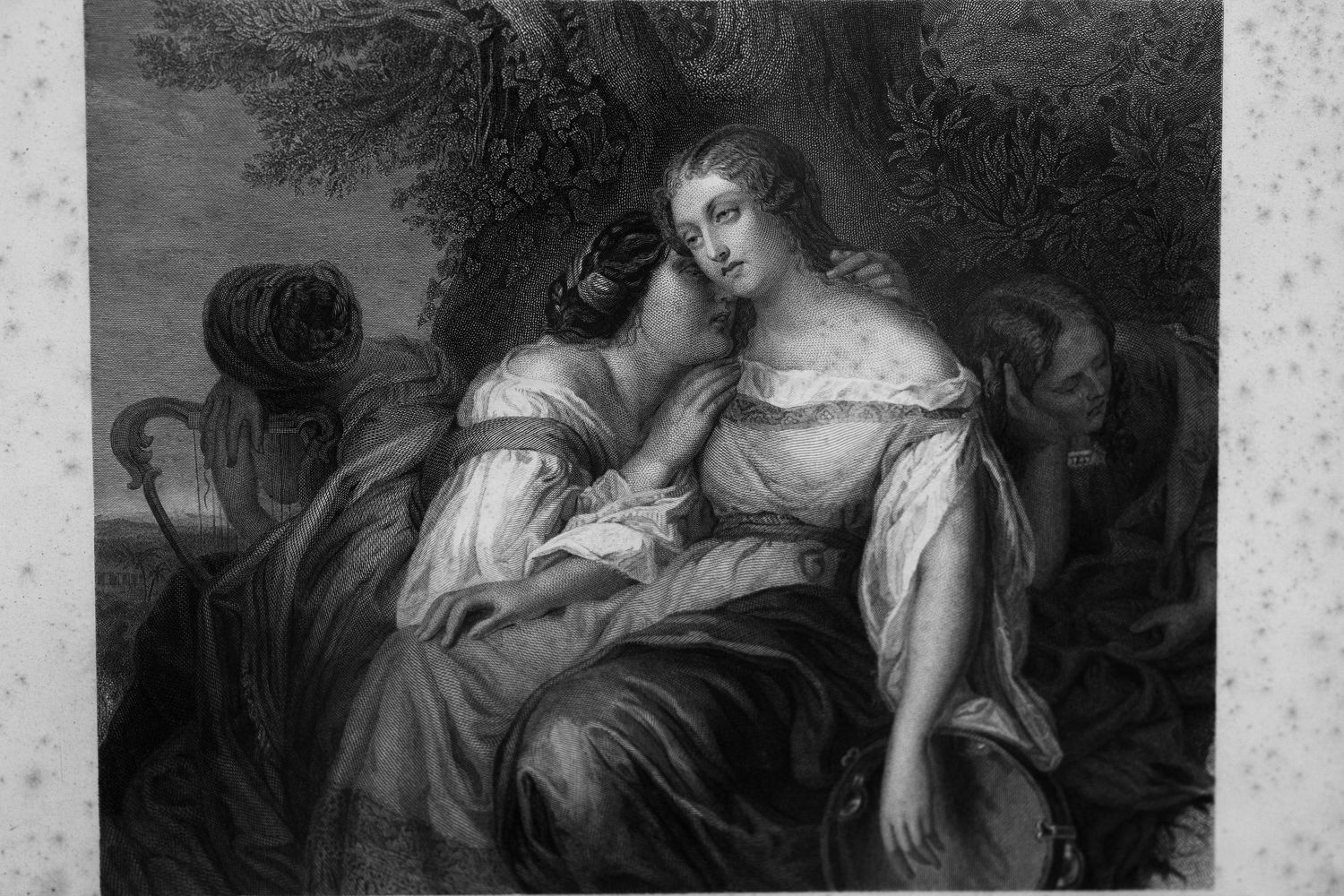 Black and white vintage engraving of two women in flowing gowns sitting close beneath a tree, one whispering a secret to the other.
