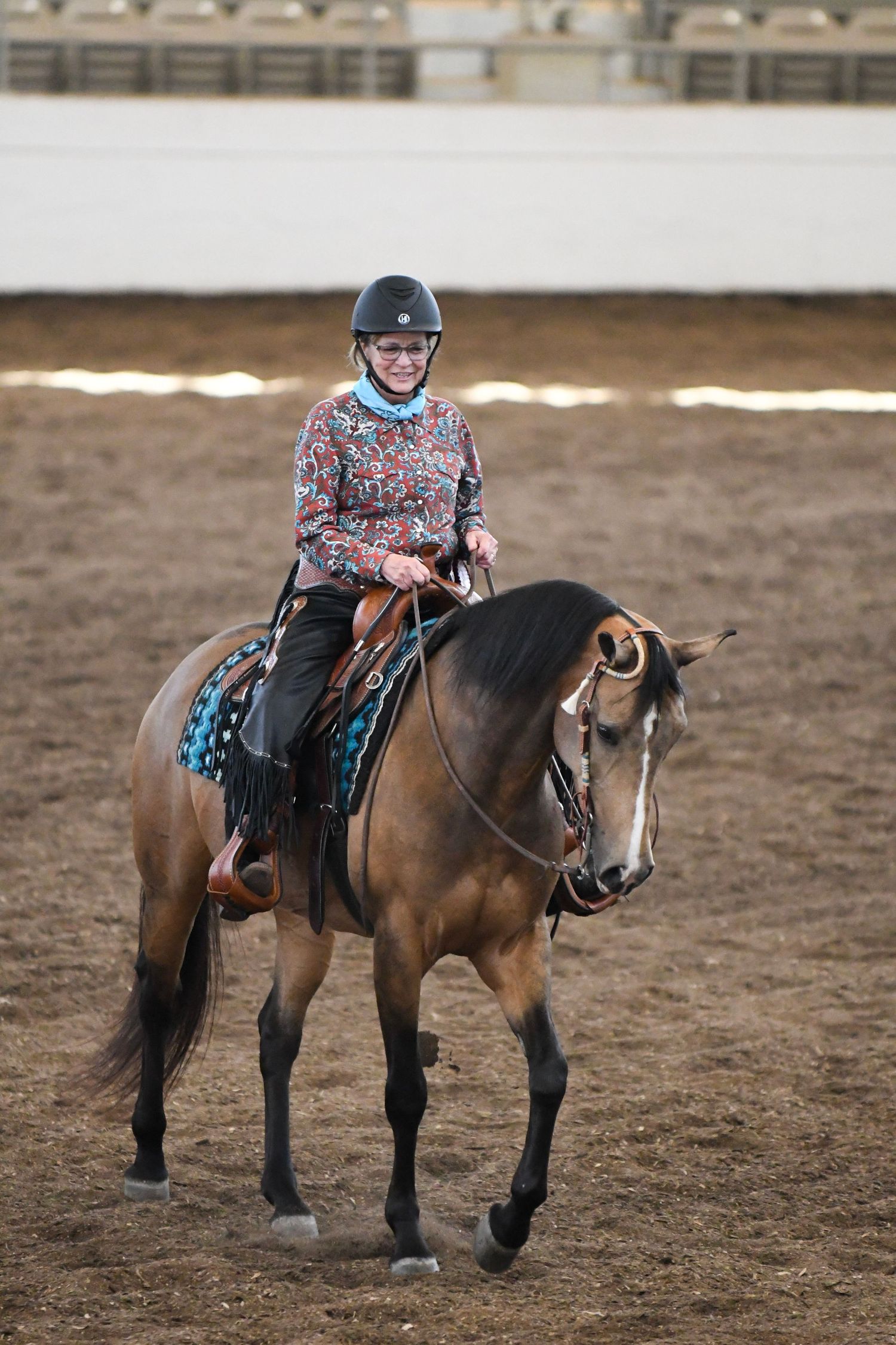 Adult woman and buckskin horse after completing a class at horse show