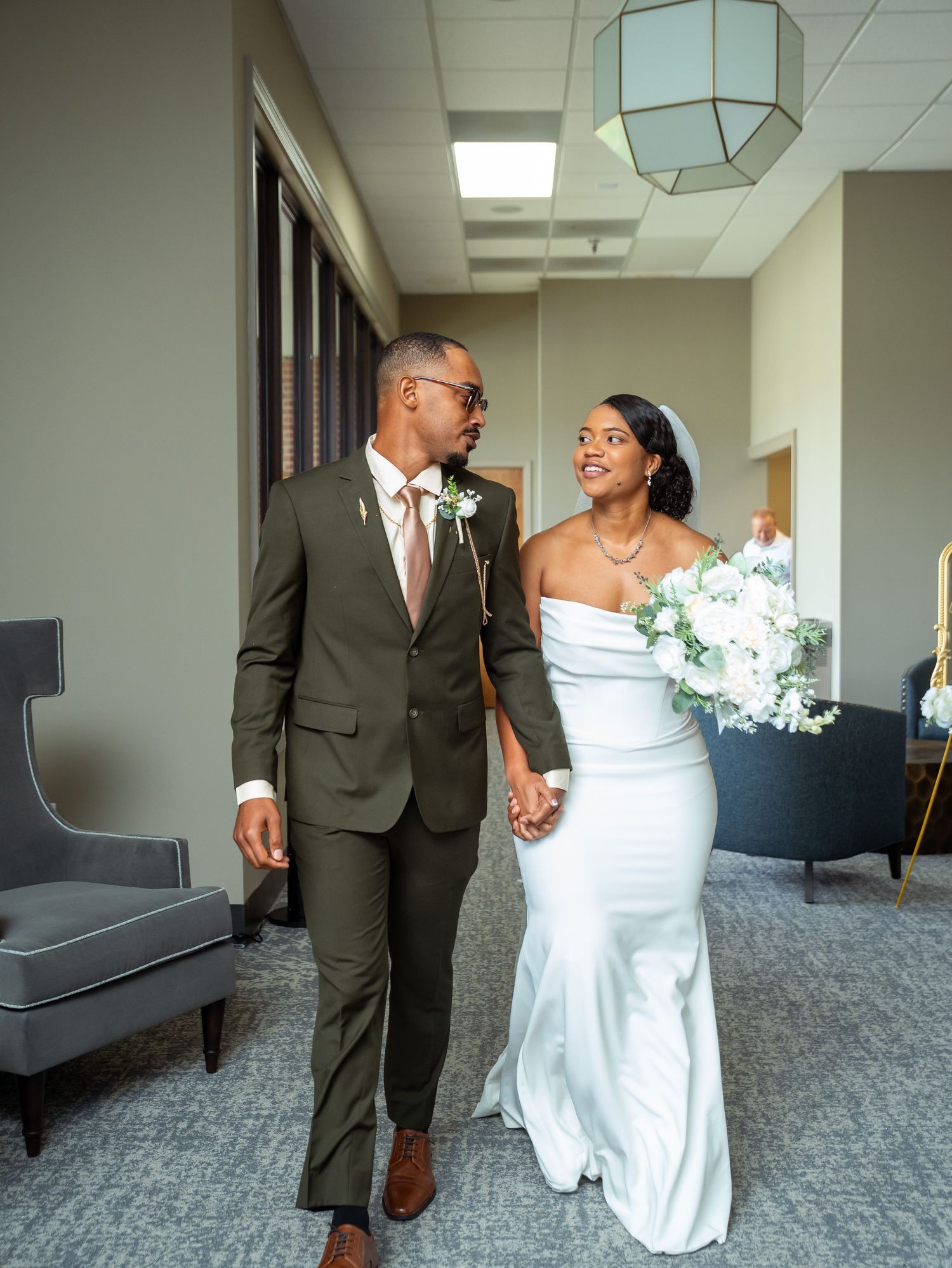 Kayela and Isaac walk together down the aisle after their wedding ceremony.
