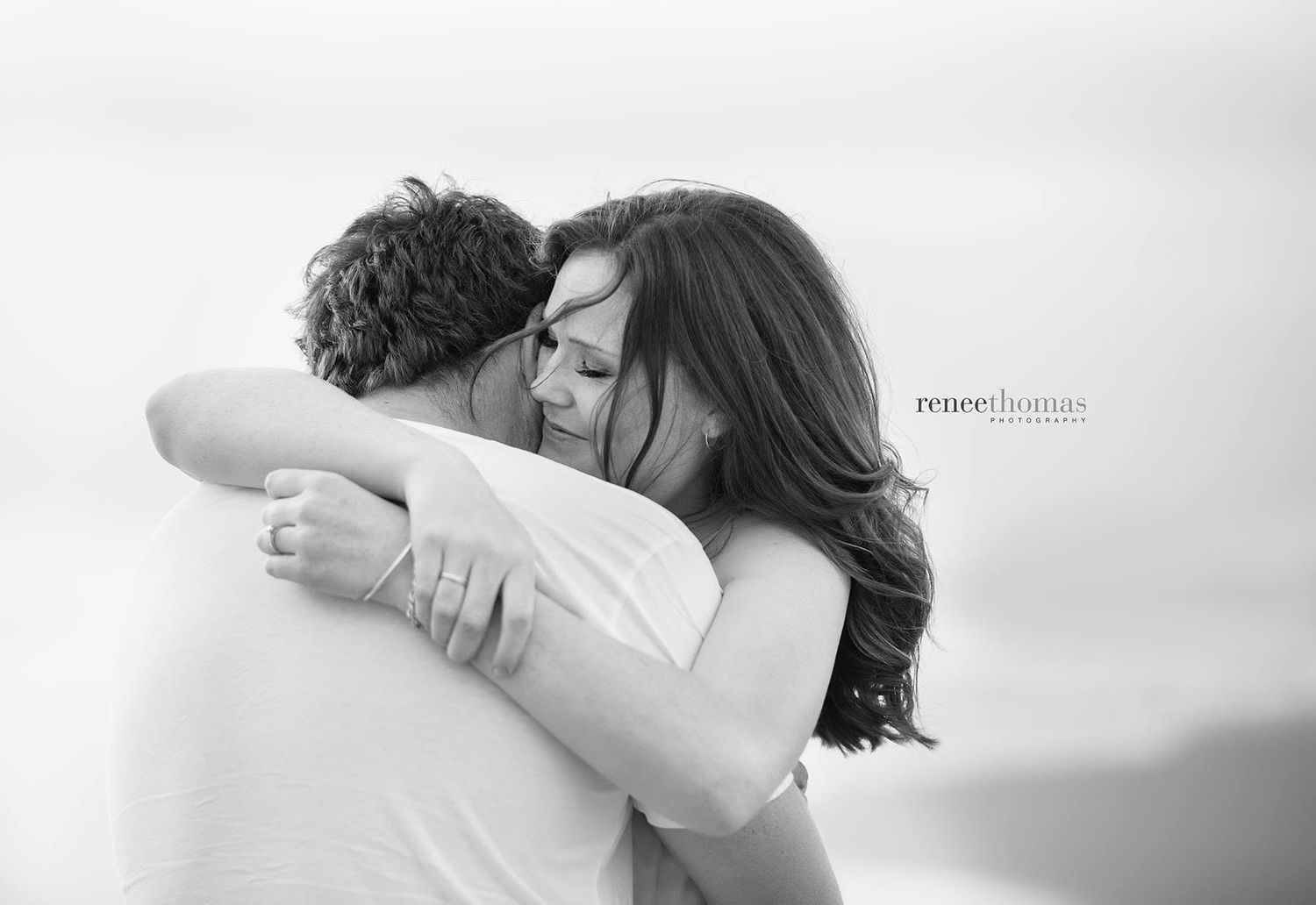 Emotional couple sharing a heartfelt embrace in a black and white portrait by Renee Thomas Photography.