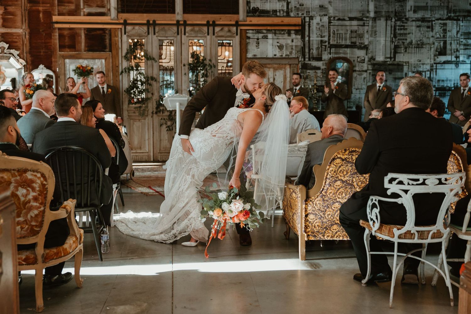 Wedding ceremony in vintage industrial venue with natural light streaming through windows.