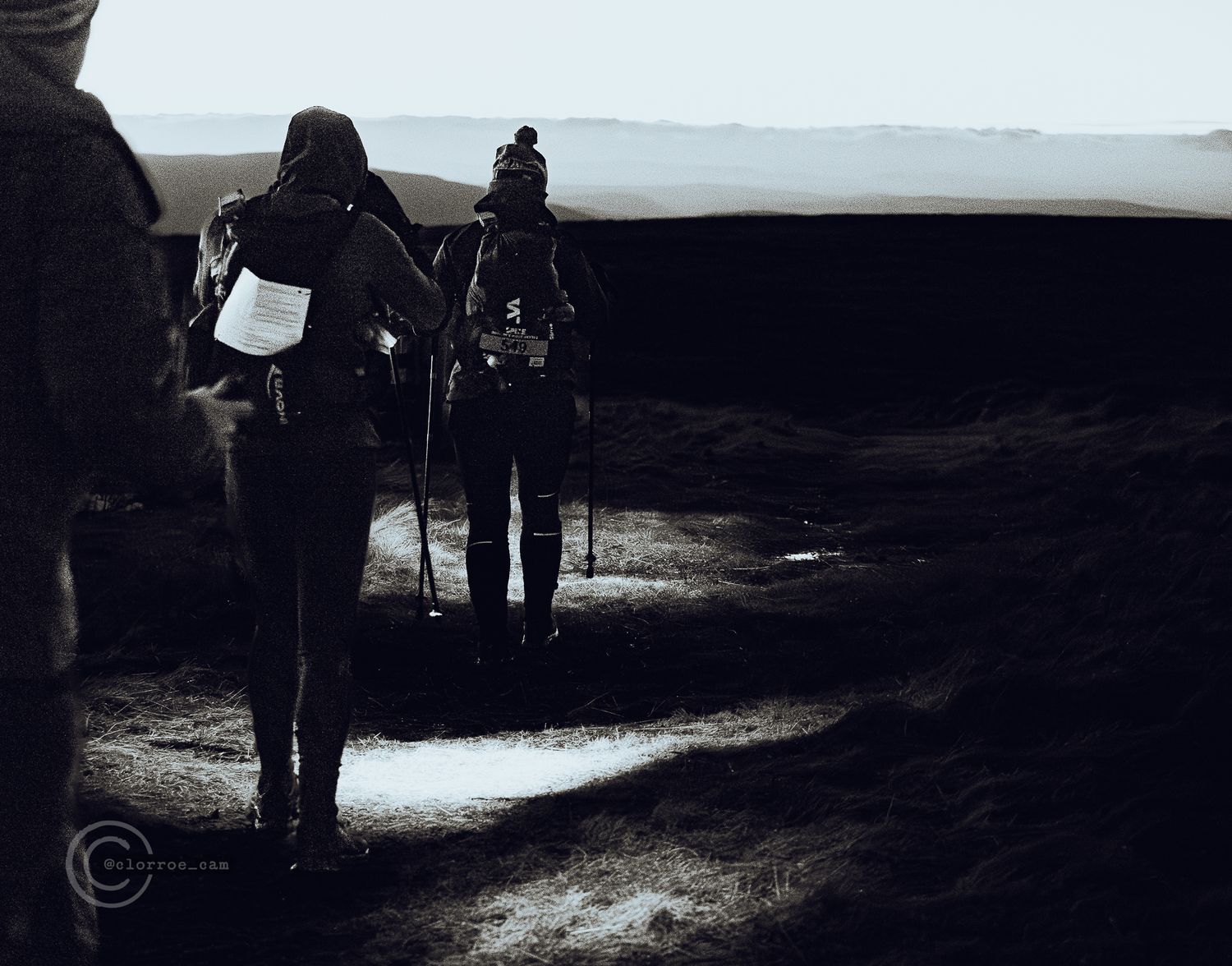 night time photo of two runners in distance