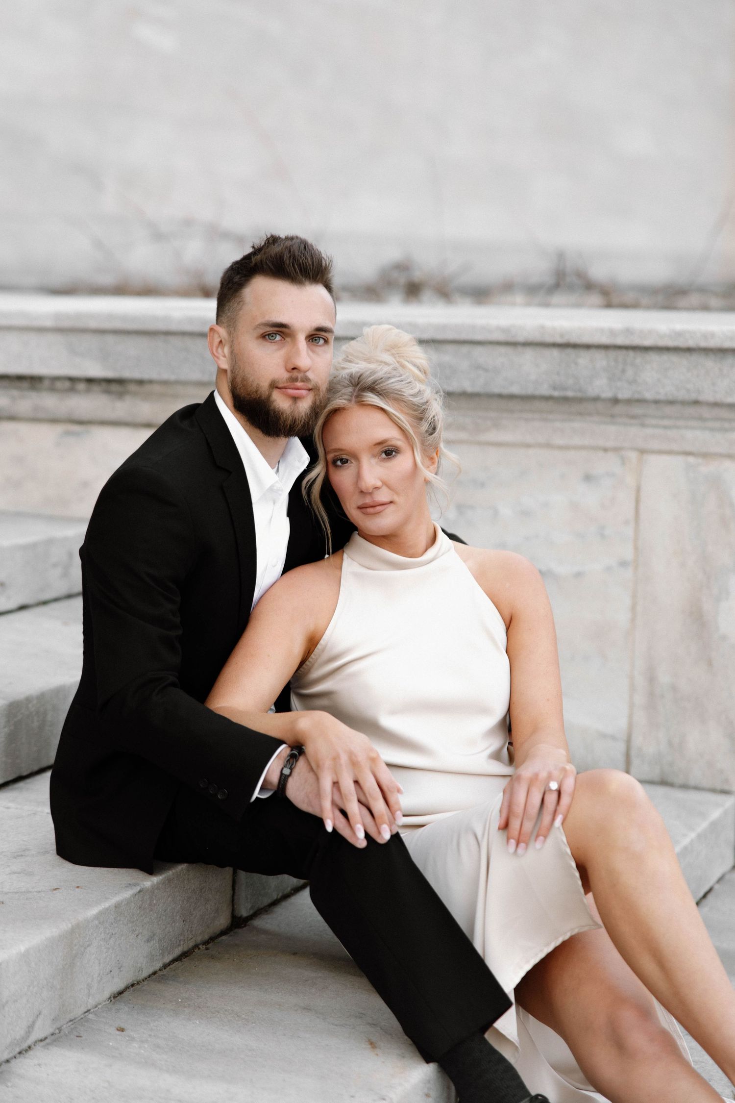 Intimate portrait of couple in formal wear seated on marble steps. Cleveland, OH