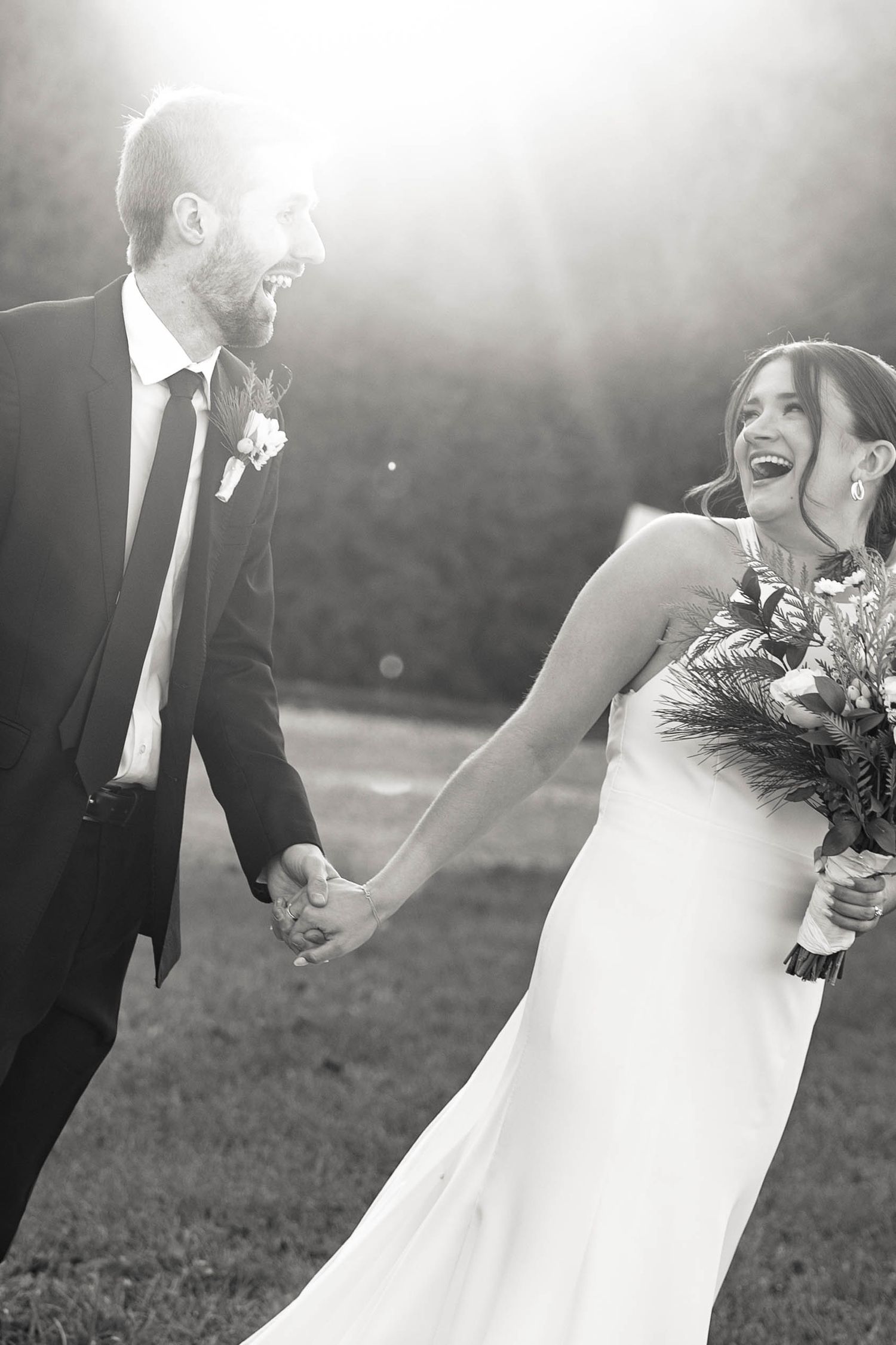 Joyful couple laughing together during sunset wedding photos. Cleveland, OH