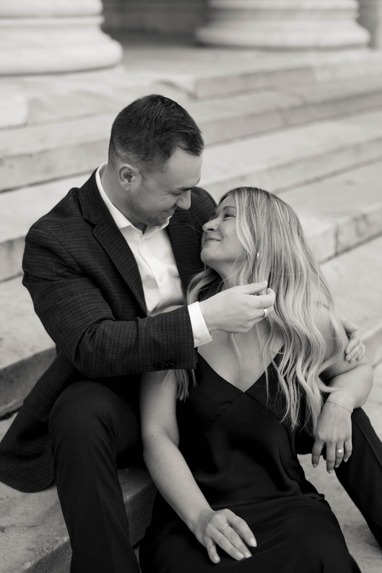 Romantic black and white portrait of couple sitting on stone steps. Cleveland, OH