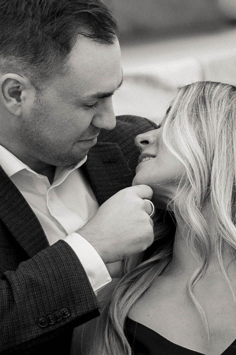Black and white romantic portrait of couple in intimate moment with groom in suit and bride with wavy blonde hair. Cleveland, OH