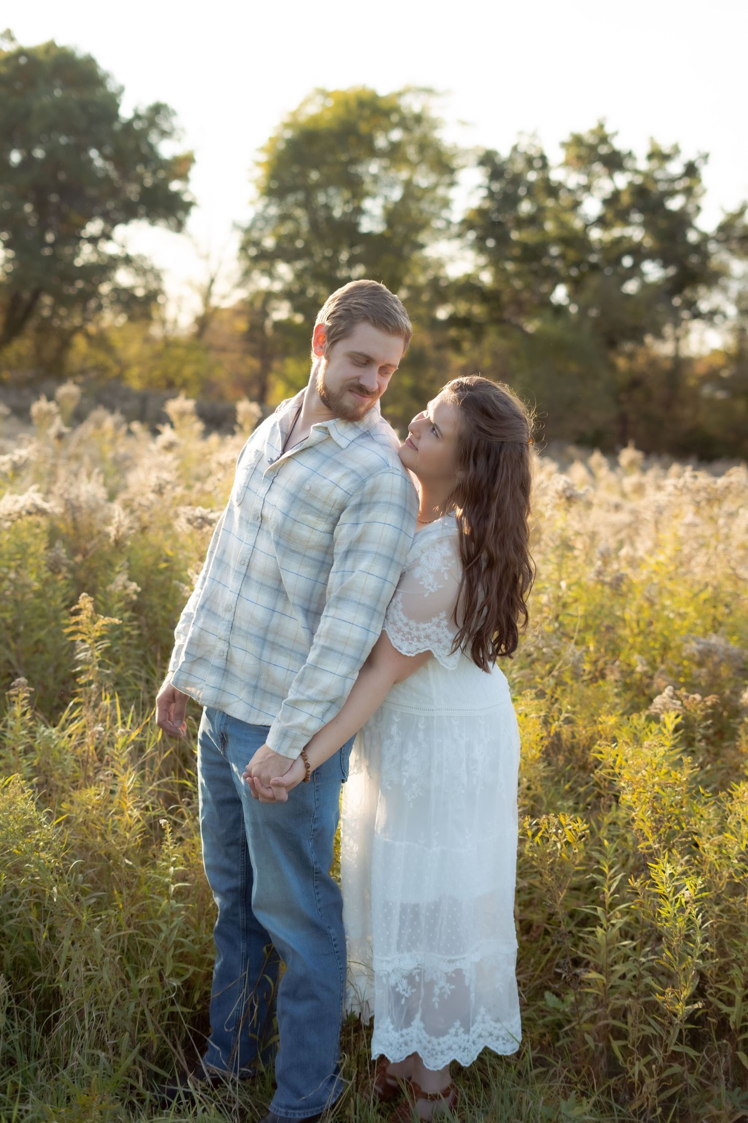 Romantic portrait in a wildflower field during golden hour.