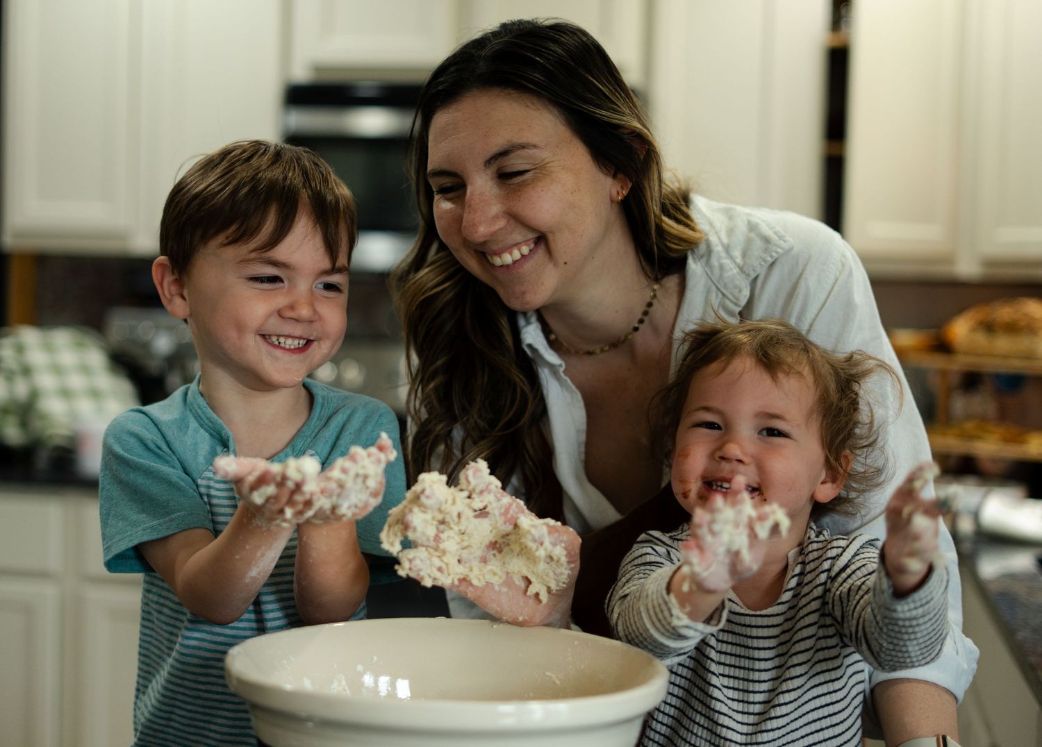 Several images show a parent and child having fun together while decorating a cake with whipped cream at a counter.