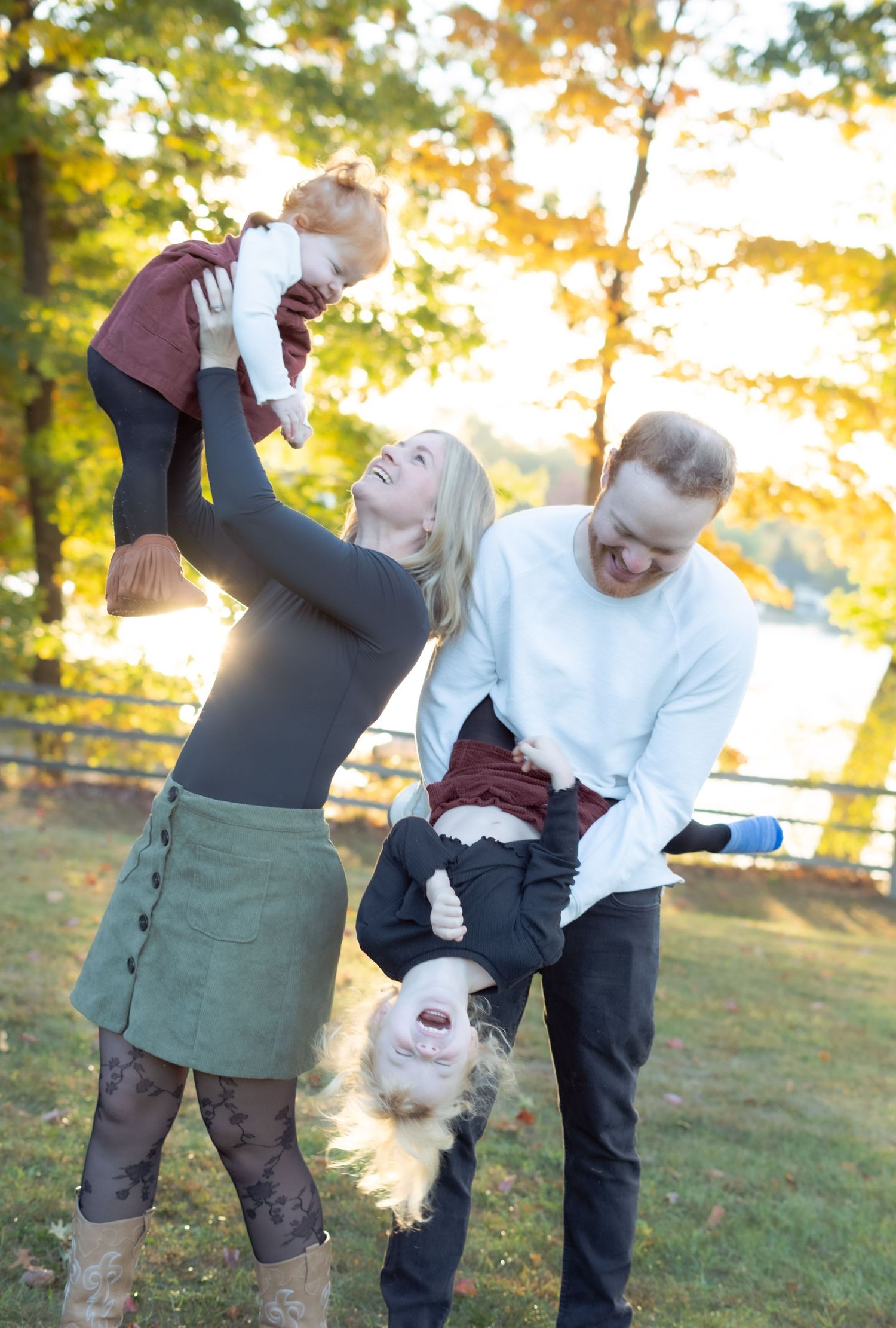A playful family moment with upside down poses and laughter during sunset.