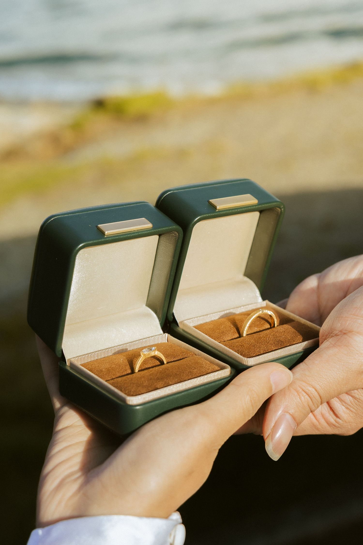 A sequence of images showing a small black box being opened to reveal a golden ring nestled in brown velvet lining.
