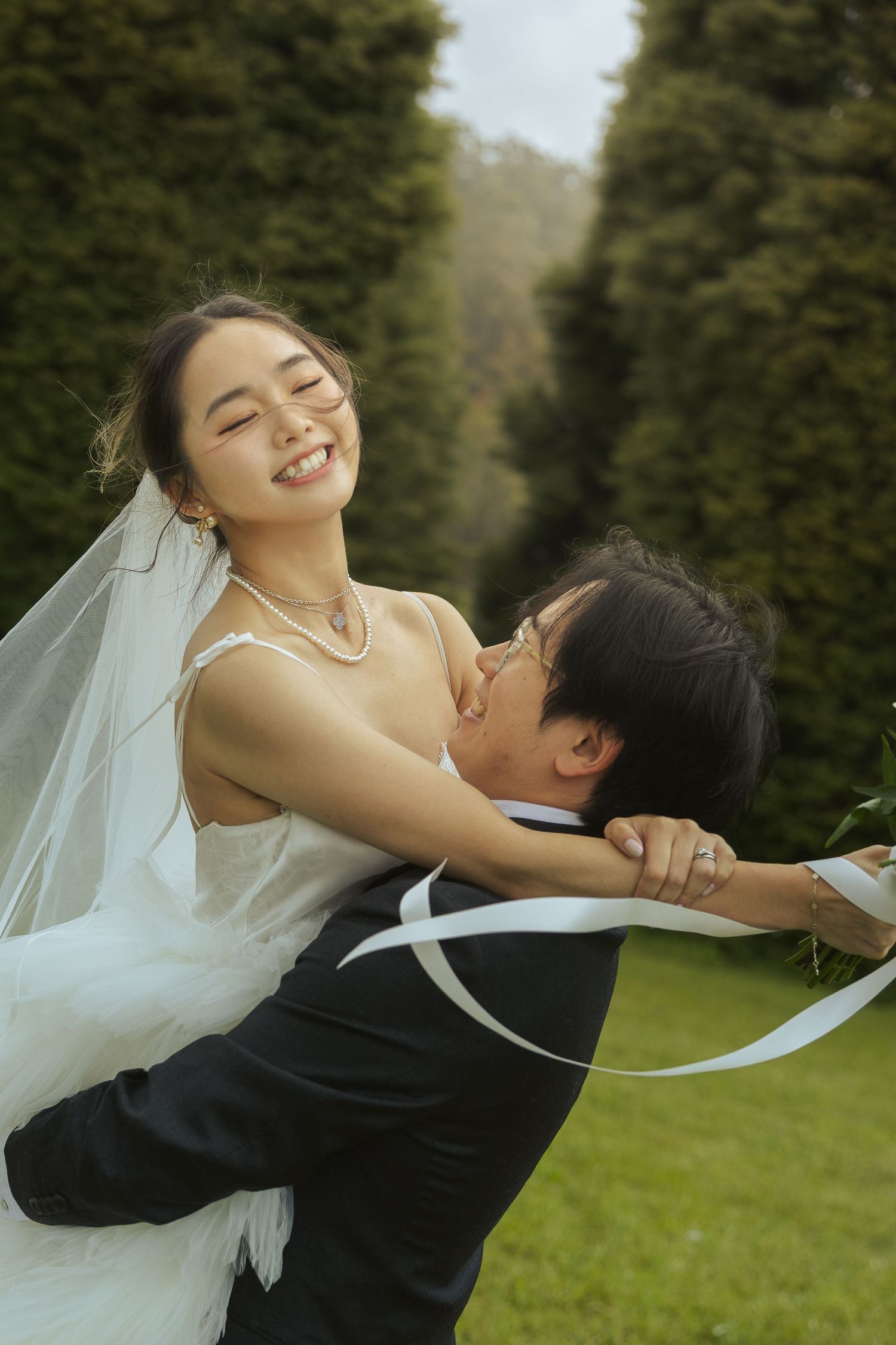 A romantic wedding photoshoot sequence showing a couple embracing joyfully in a garden setting.