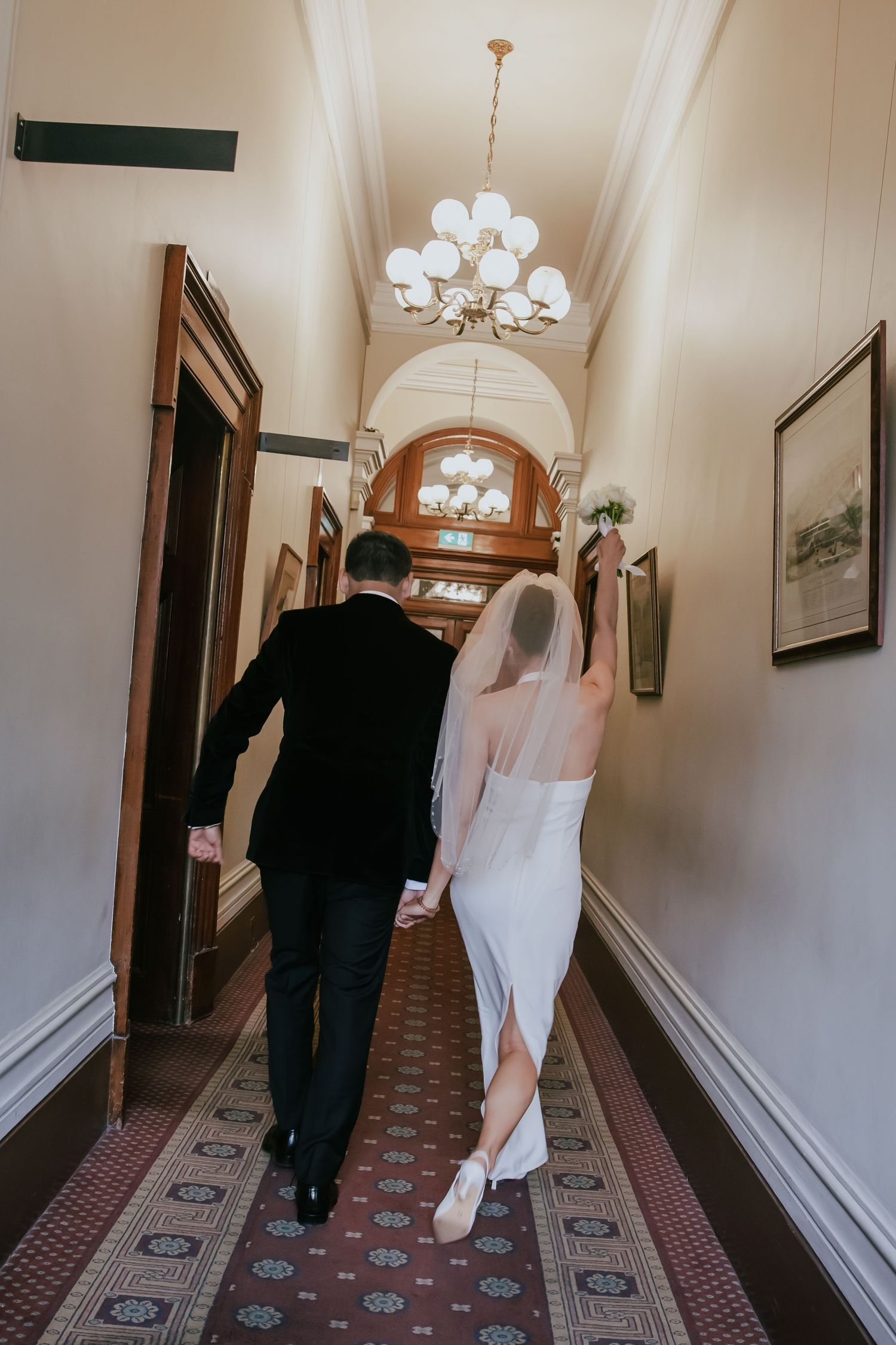 A sequence of photos shows a couple walking down an elegant hallway with patterned carpet and white walls.