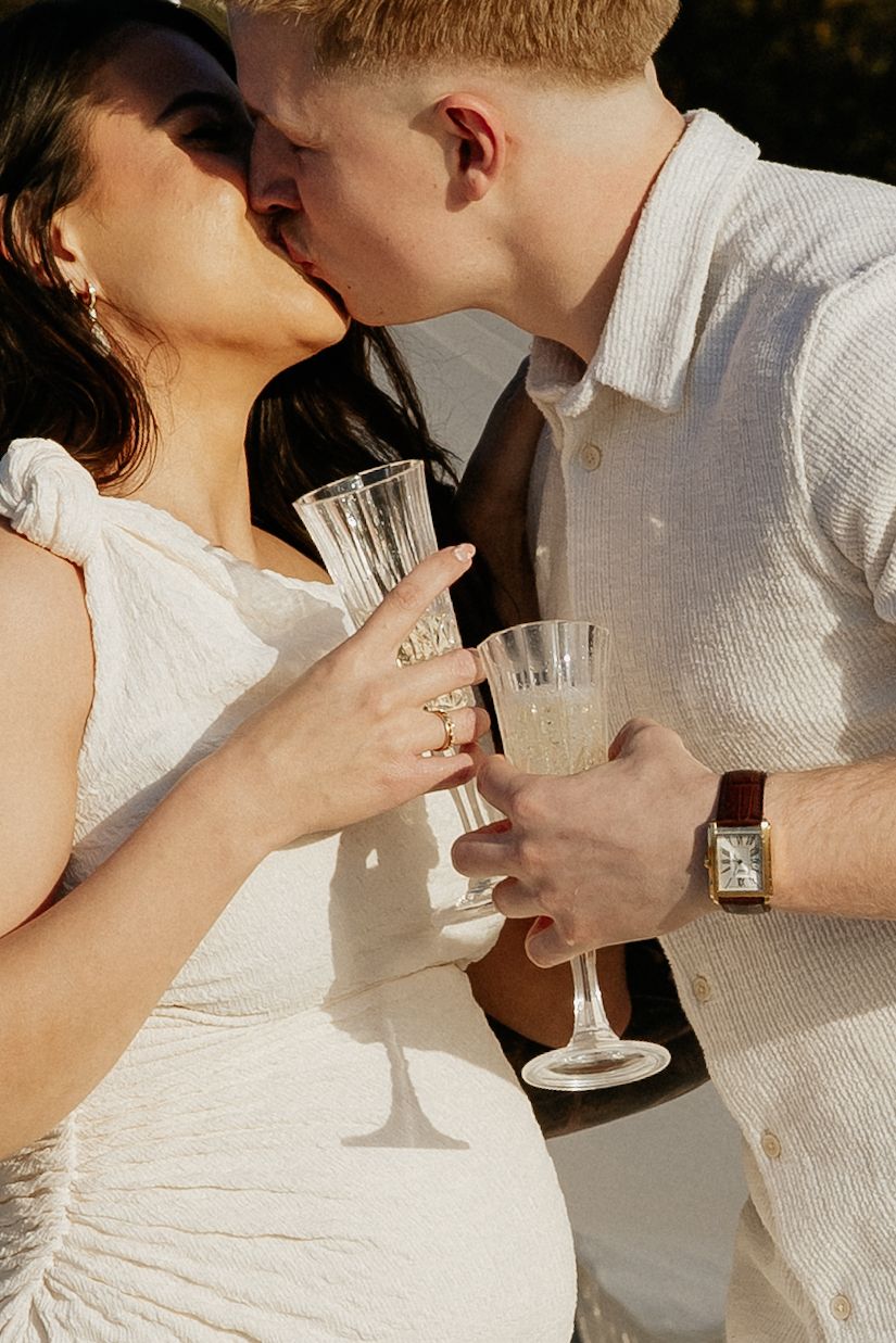 A couple in wedding attire shares champagne glasses in a romantic sequence of photos.