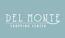 A blue-tinted architectural detail showing part of a shopping center sign reading 'DEL MONTE'.