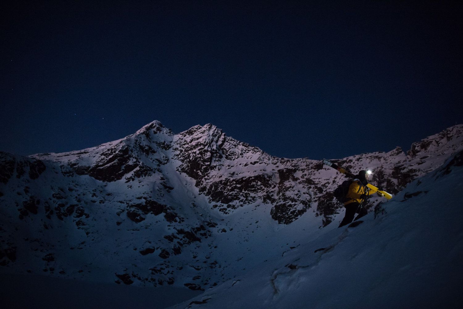 Documentary directed by Holly Wademan about a freeskiier  ascending a steep snow-covered peak under a deep blue starry sky.