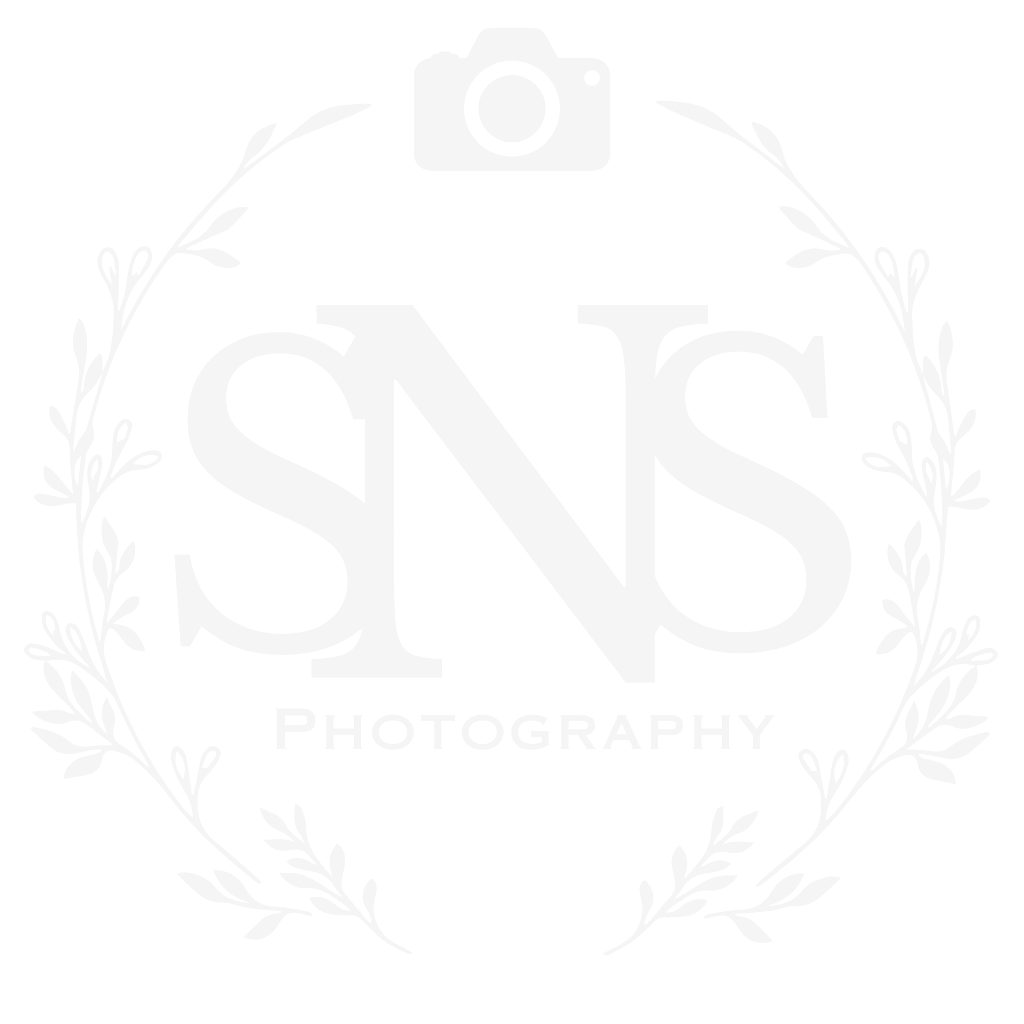 SNS Photography logo with camera icon and elegant laurel wreath design in light gray.
