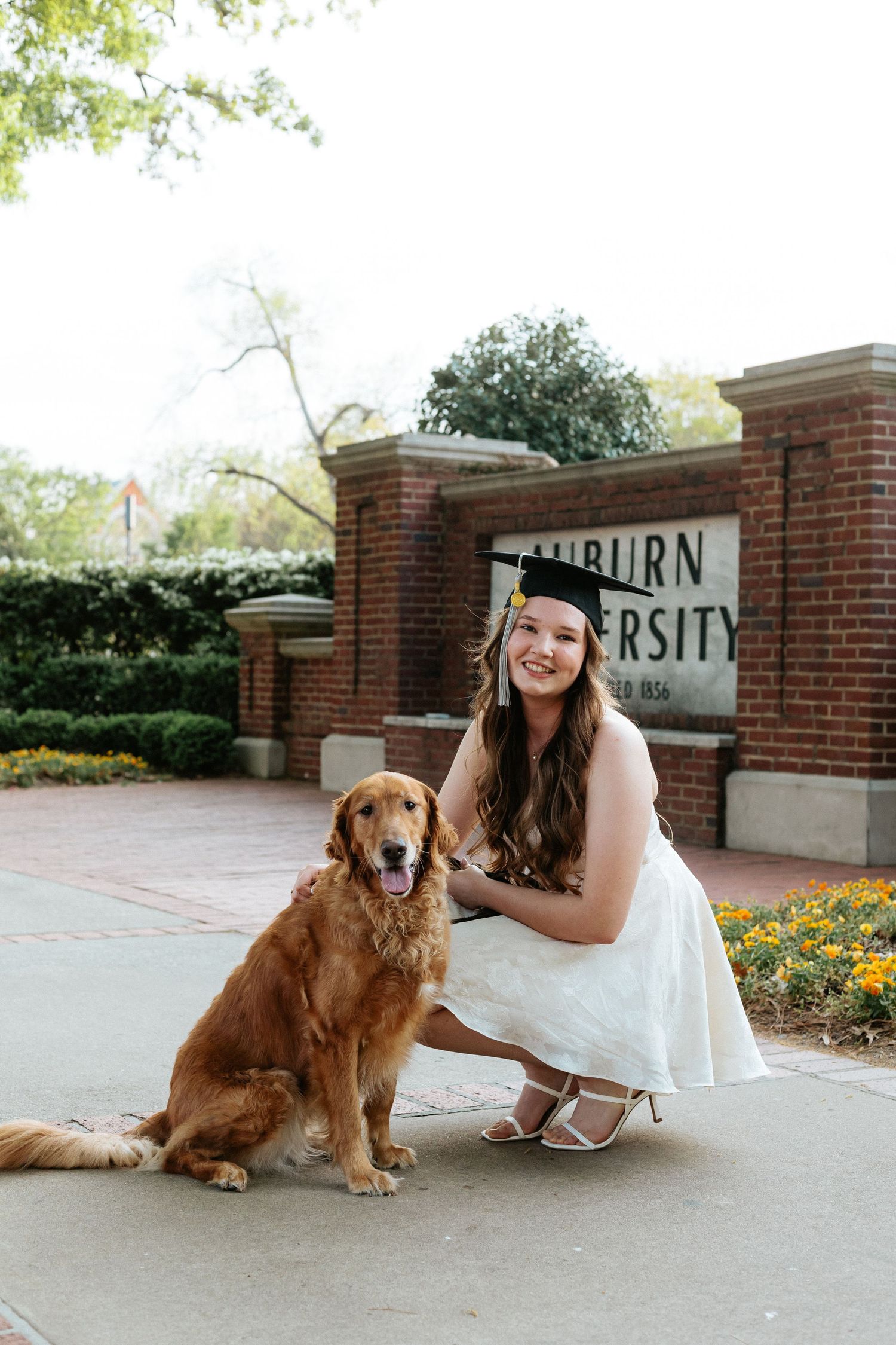Graduate celebrating during a portrait session in Auburn, Alabama with a fun, candid and joyful vibe