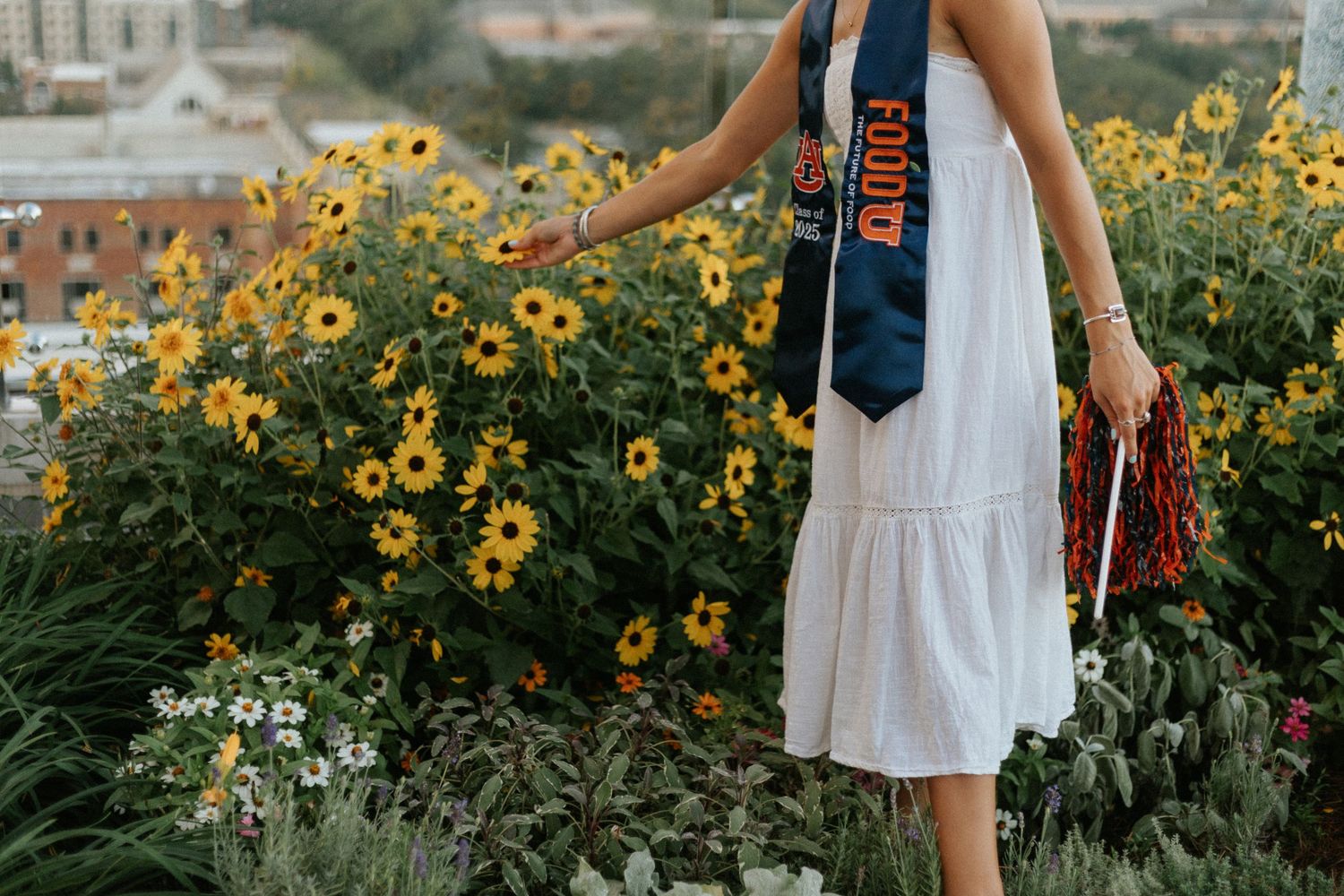 Graduate celebrating during a portrait session in Auburn, Alabama with a fun, candid and joyful vibe